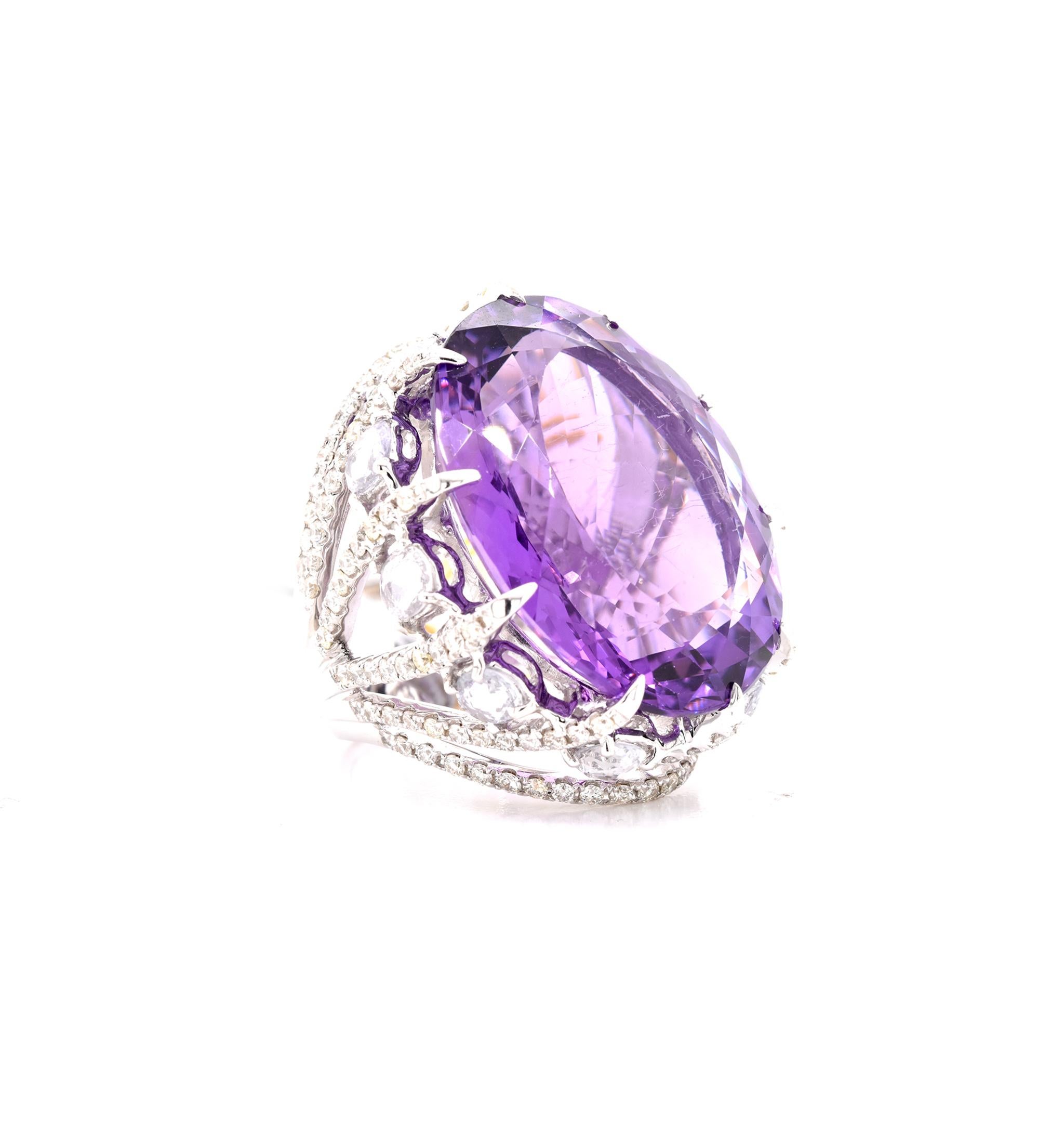 Designer: custom
Material: 18K white gold
Amethyst: 1 oval cut = 39.71ct
White Sapphire: 10 oval cut = 2.66cttw
Diamond: 138 round cut = 1.70cttw
Color: G
Clarity: VS
Ring Size: 6 (please allow up to additional business days for sizing