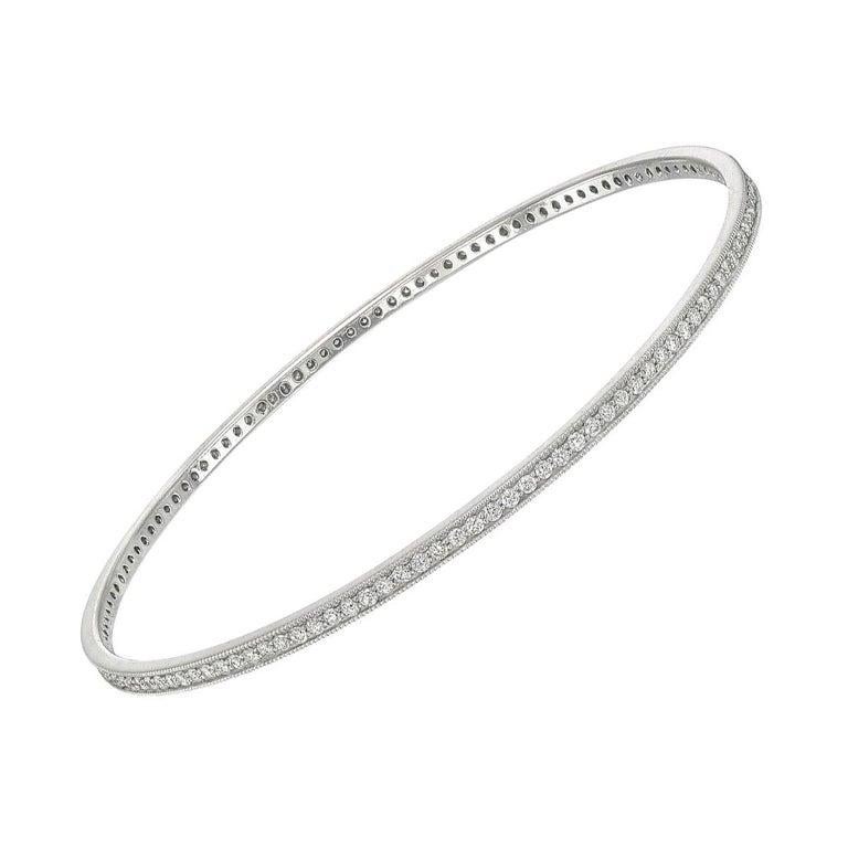 Circular-shaped bangle bracelet, set with round brilliant-cut diamonds weighing approximately 2.00 total carats, in polished 18k white gold. Slip on-style.