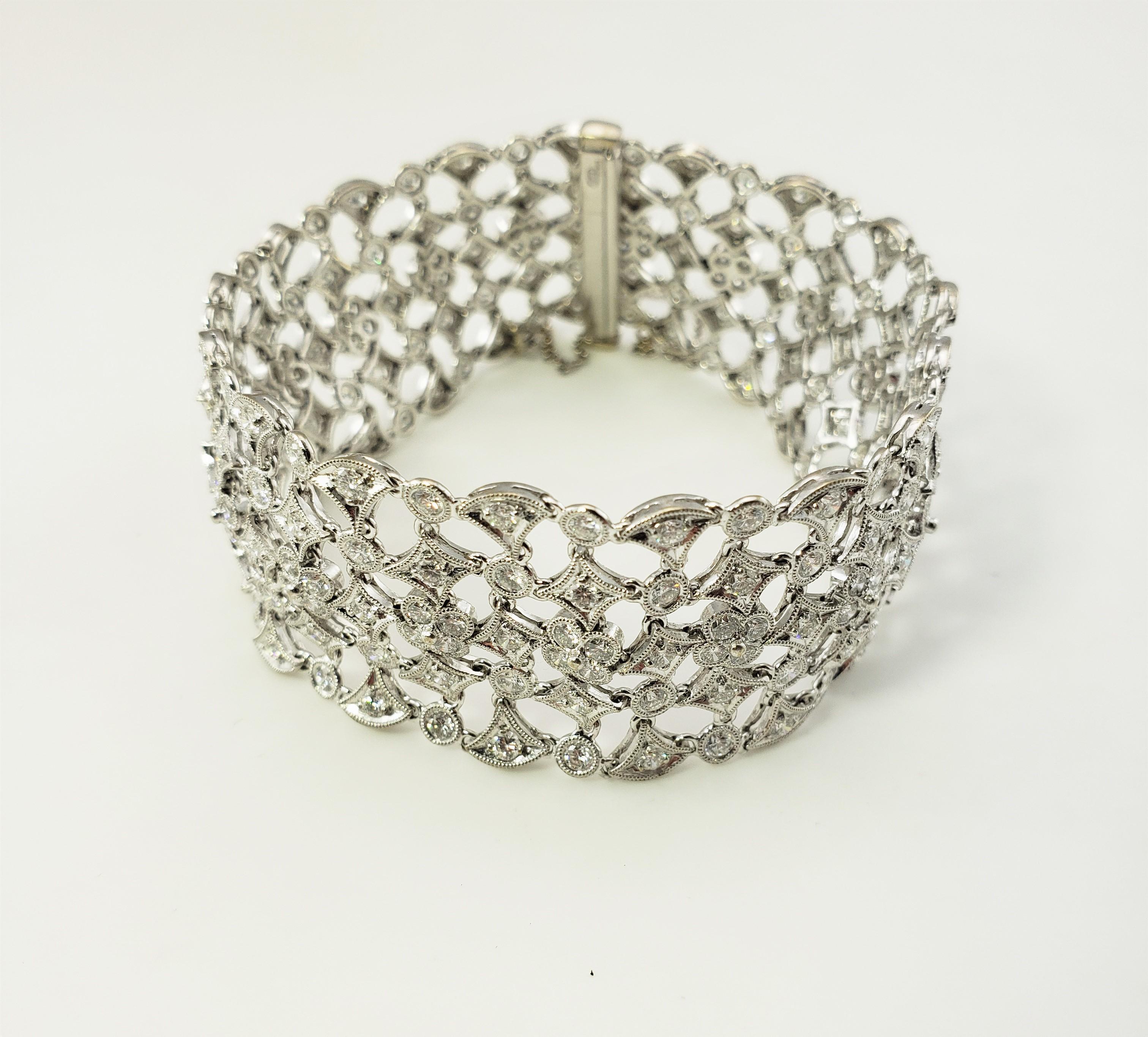 18 Karat White Gold and Diamond Bracelet-

This spectacular 18K white gold bracelet features 221 round brilliant cut diamond set in an exquisite open design.  Width:  24 mm.

Approximate total diamond weight:  4 cts.
Diamond color:  G

Diamond