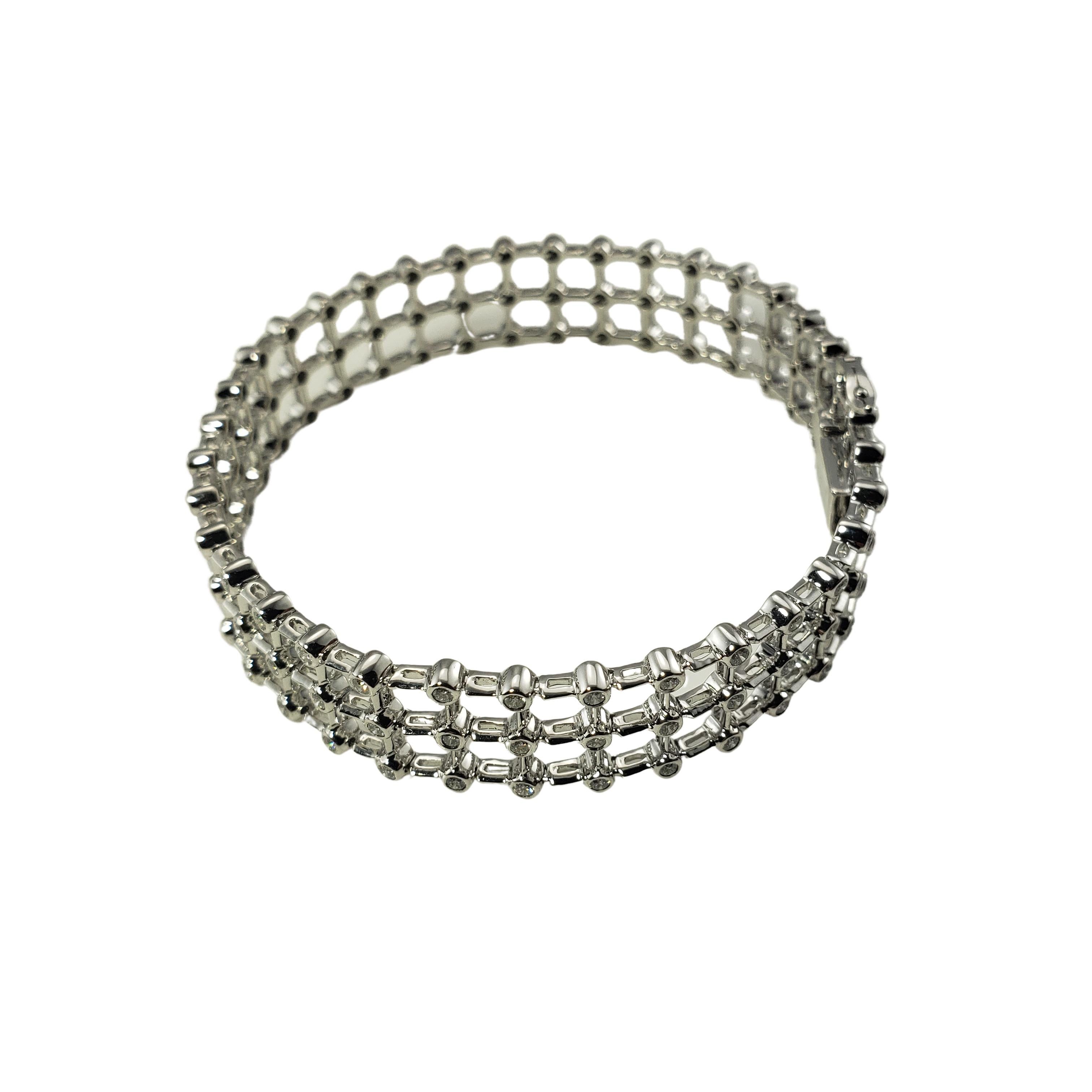 18 Karat White Gold and Diamond Bracelet-

This spectacular sparkling bracelet features 108 round brilliant cut diamonds set in beautifully detailed 18K white gold.  Width:  12 mm.

Approximate total diamond weight:   1.88 ct.

Diamond color: 