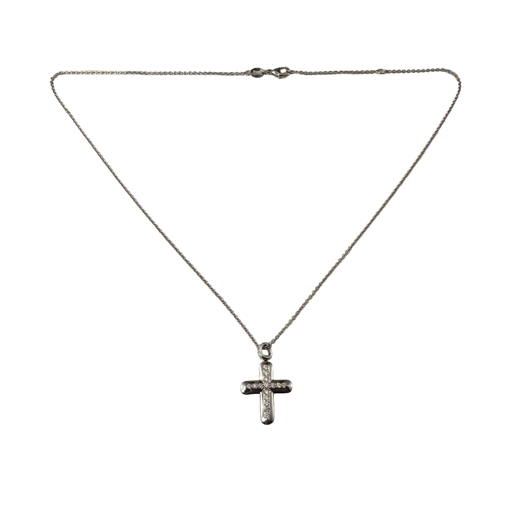 18K White Gold and Diamond Cross Pendant Necklace-

This sparkling diamond cross features 20 round brilliant cut diamonds set in 18K white gold.  Suspends from a classic cable chain.

Approximate total diamond weight: .20 ct.

Diamond color: