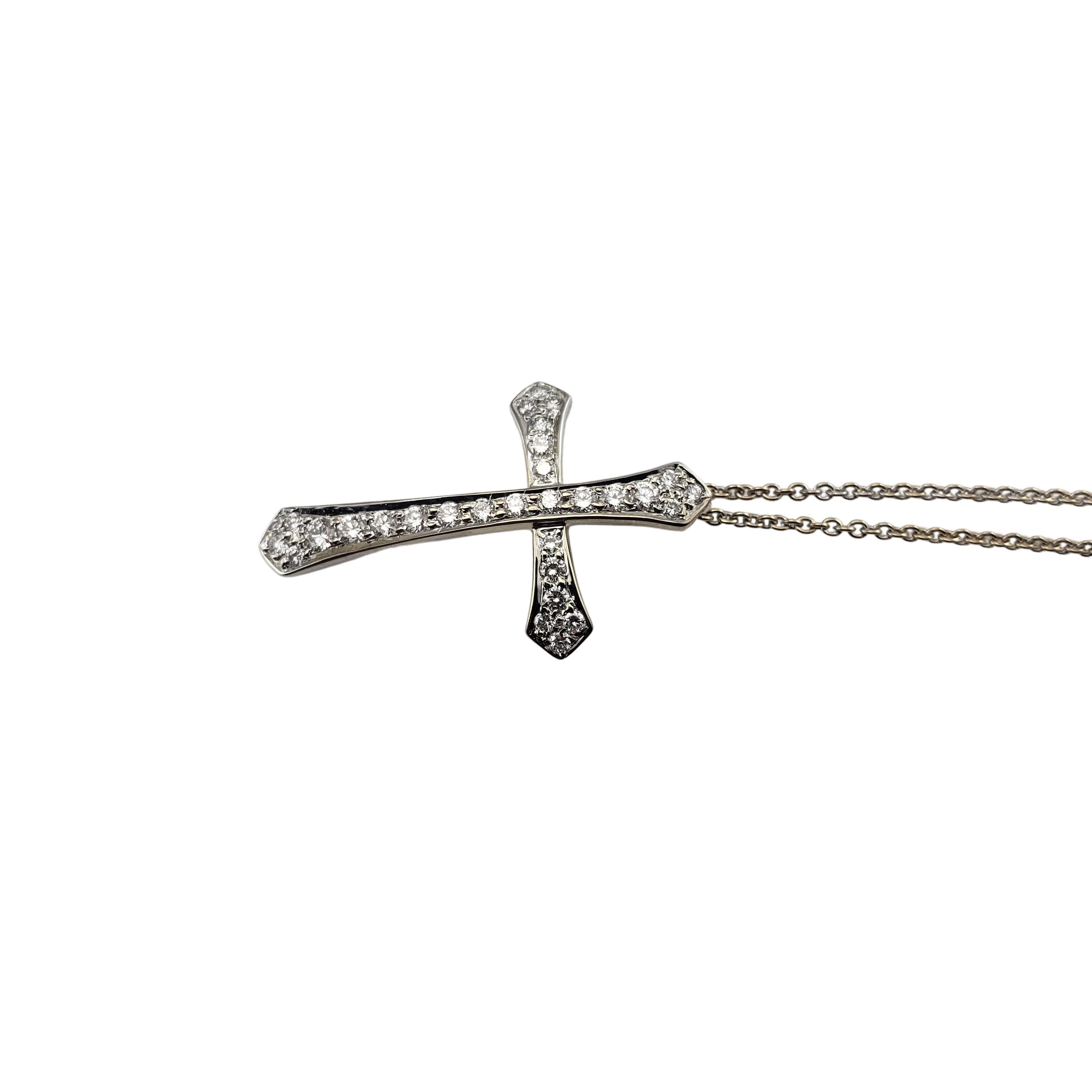 18 Karat White Gold and Diamond Cross Pendant Necklace-

This lovely cross pendant features 29 round brilliant cut diamonds set in classic 18 white gold.  Suspends from a classic cable necklace. 

Approximate total diamond weight:  .55 ct.

Diamond