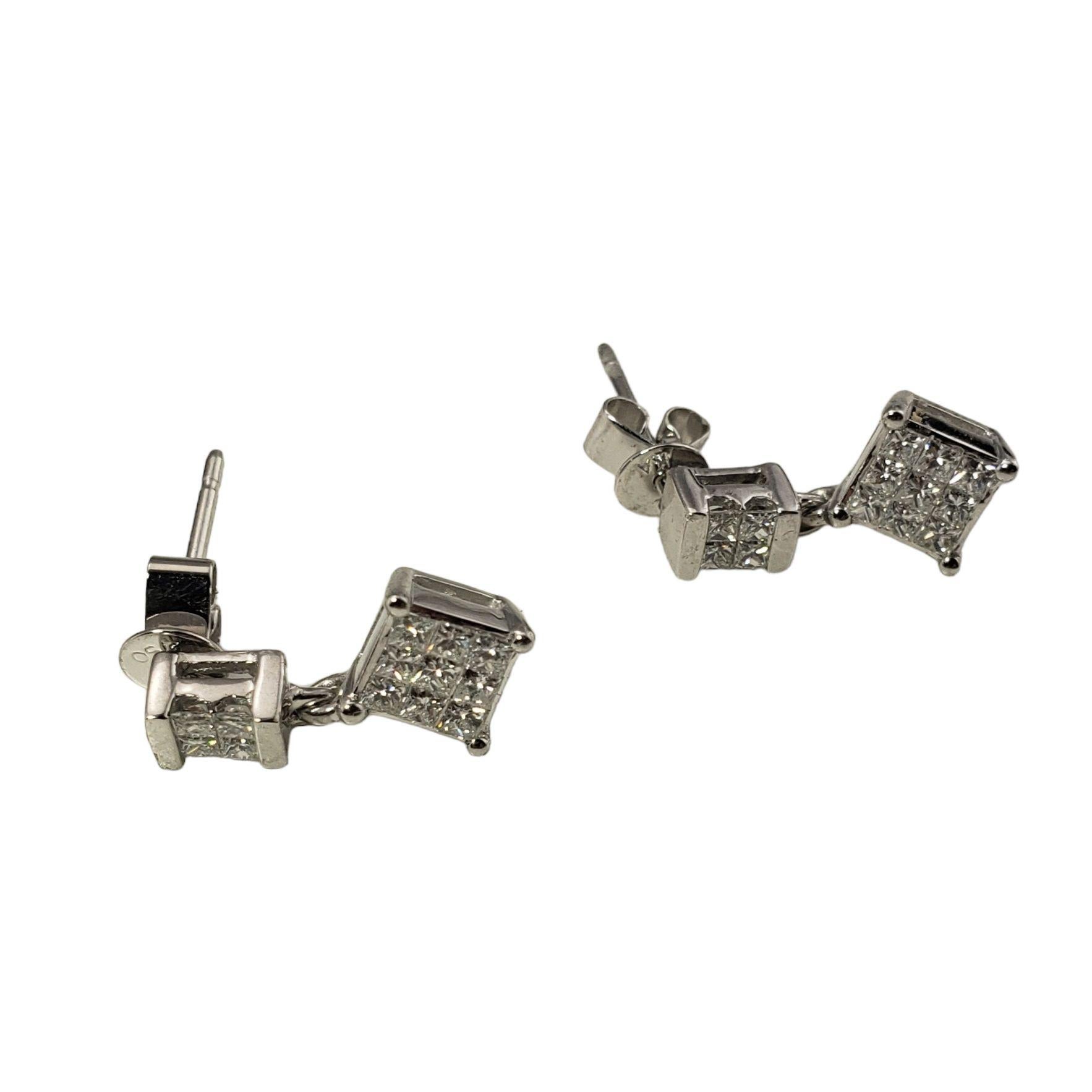Vintage 18 Karat White Gold and Diamond Dangle Earrings-

These sparkling dangle earrings each feature 13 princess cut diamonds set in classic 18K white gold. Push back closures.

Approximate total diamond weight: .78 ct.

Diamond clarity: