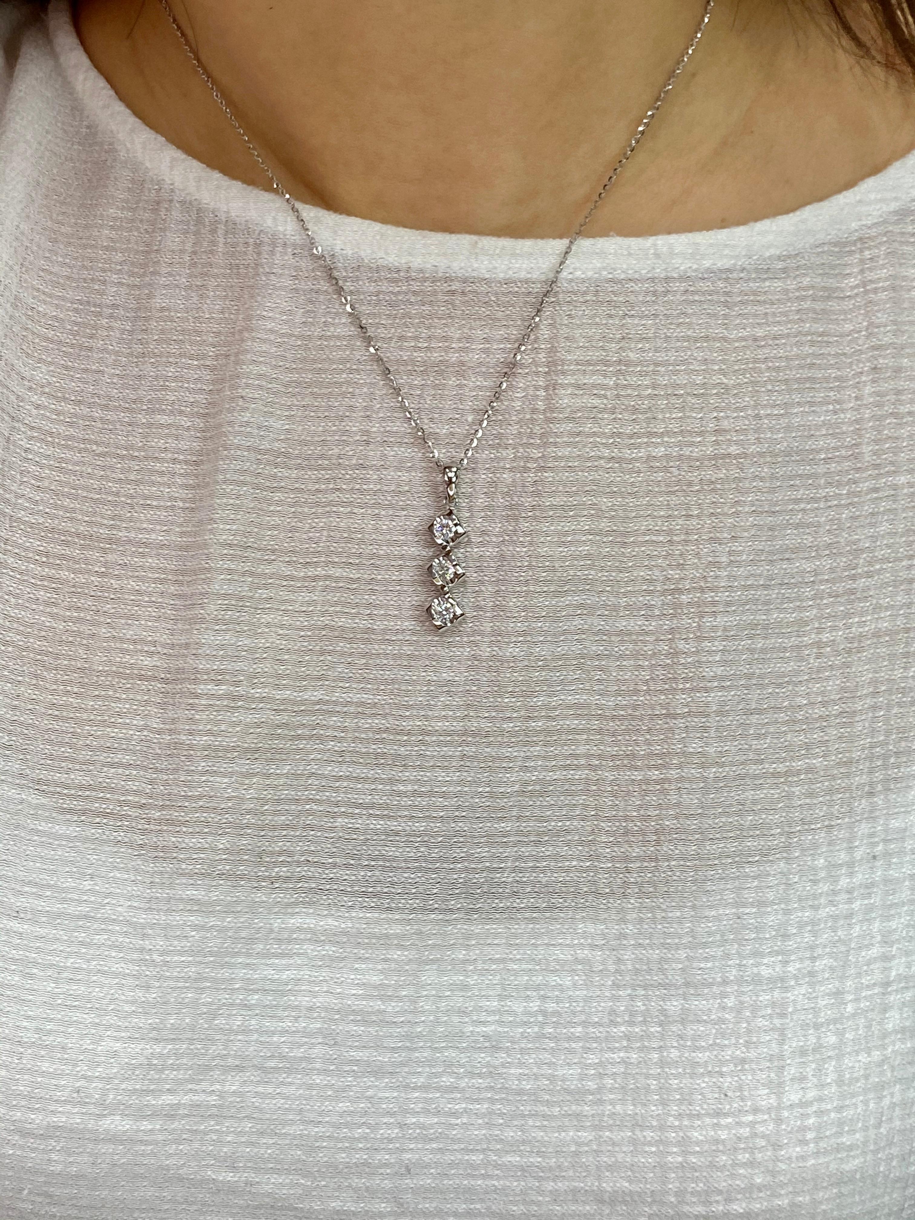 Here is a nice diamond pendant. The pendant is set in 18k white gold and diamonds. There are 3 diamonds totaling 0.50 cts. Each diamond is about 0.16Cts. It sparkles with fire. The pendant is beautiful with heart shaped motifs on the sides.  Photos