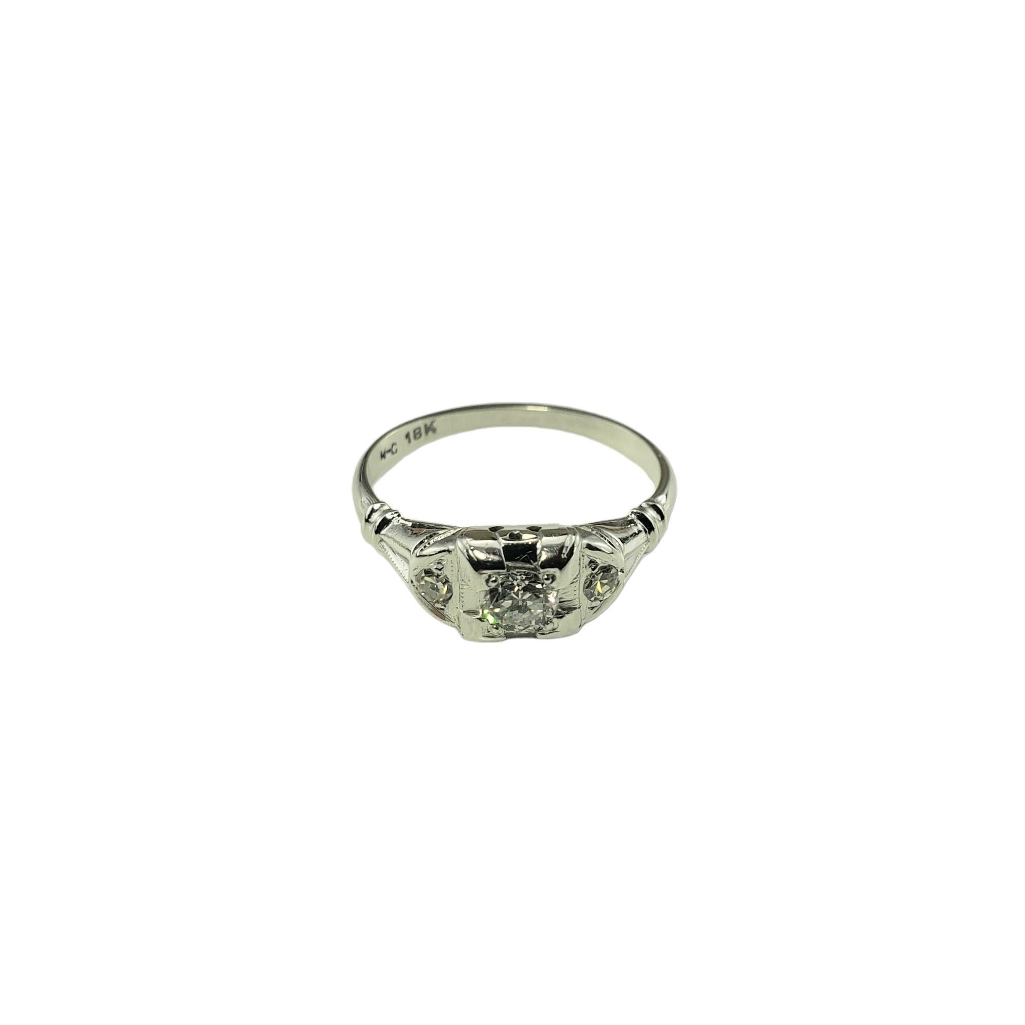 18 Karat White Gold Diamond Engagement Ring Size 6-

This sparkling ring features one center round brilliant cut diamond (.18 ct.) and two round single cut diamonds set in classic 18K white gold.  Width:  6 mm.  
Shank:  1.4 mm.

Approximate total