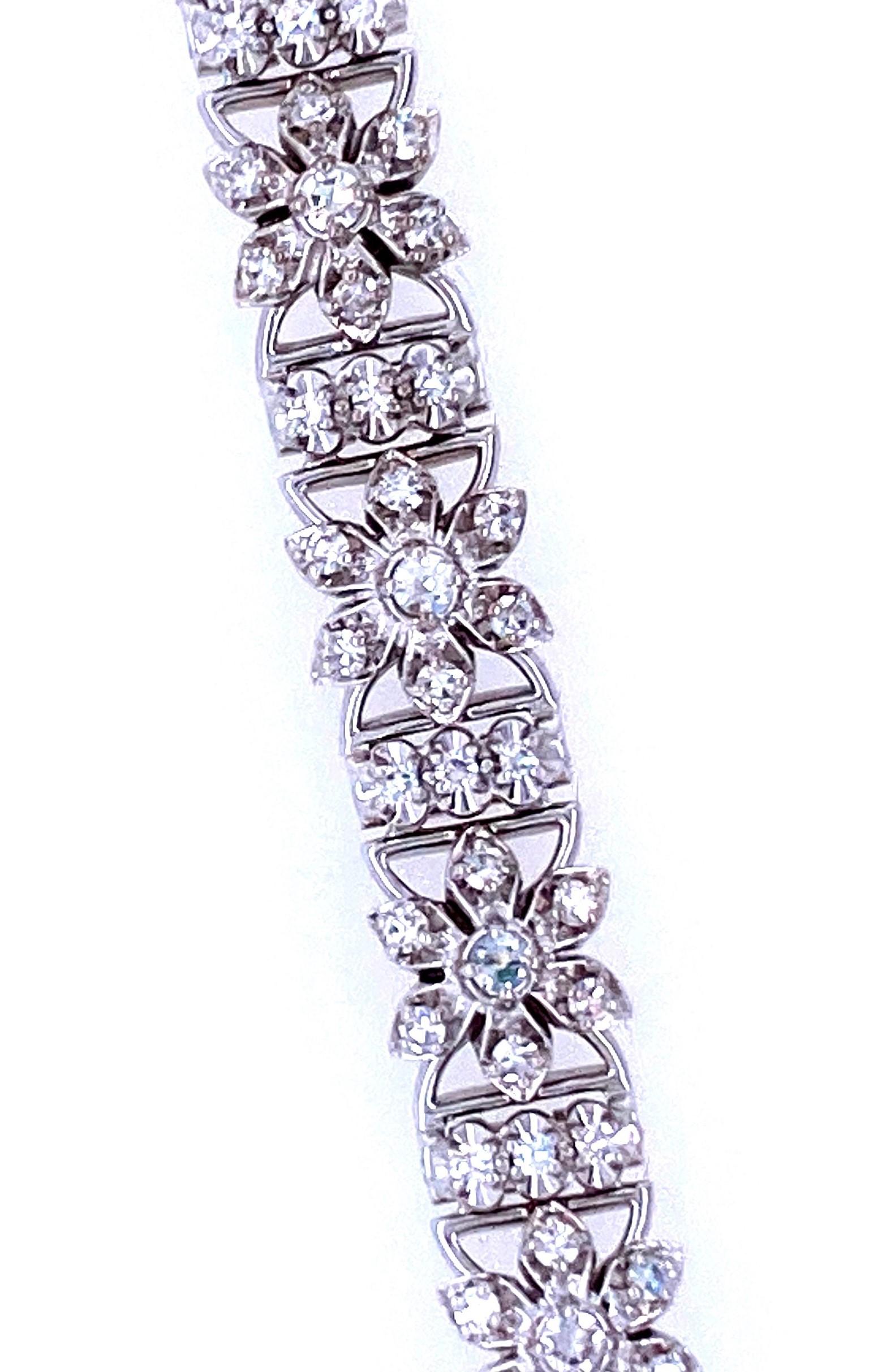 One 18 karat white gold (stamped 18K JABEL) diamond floral link bracelet set with 139 single cut diamonds, with H/I color and SI clarity. The bracelet measures 6.75 inches in length and 7.75mm wide and is secured with a box clasp and safety chain.