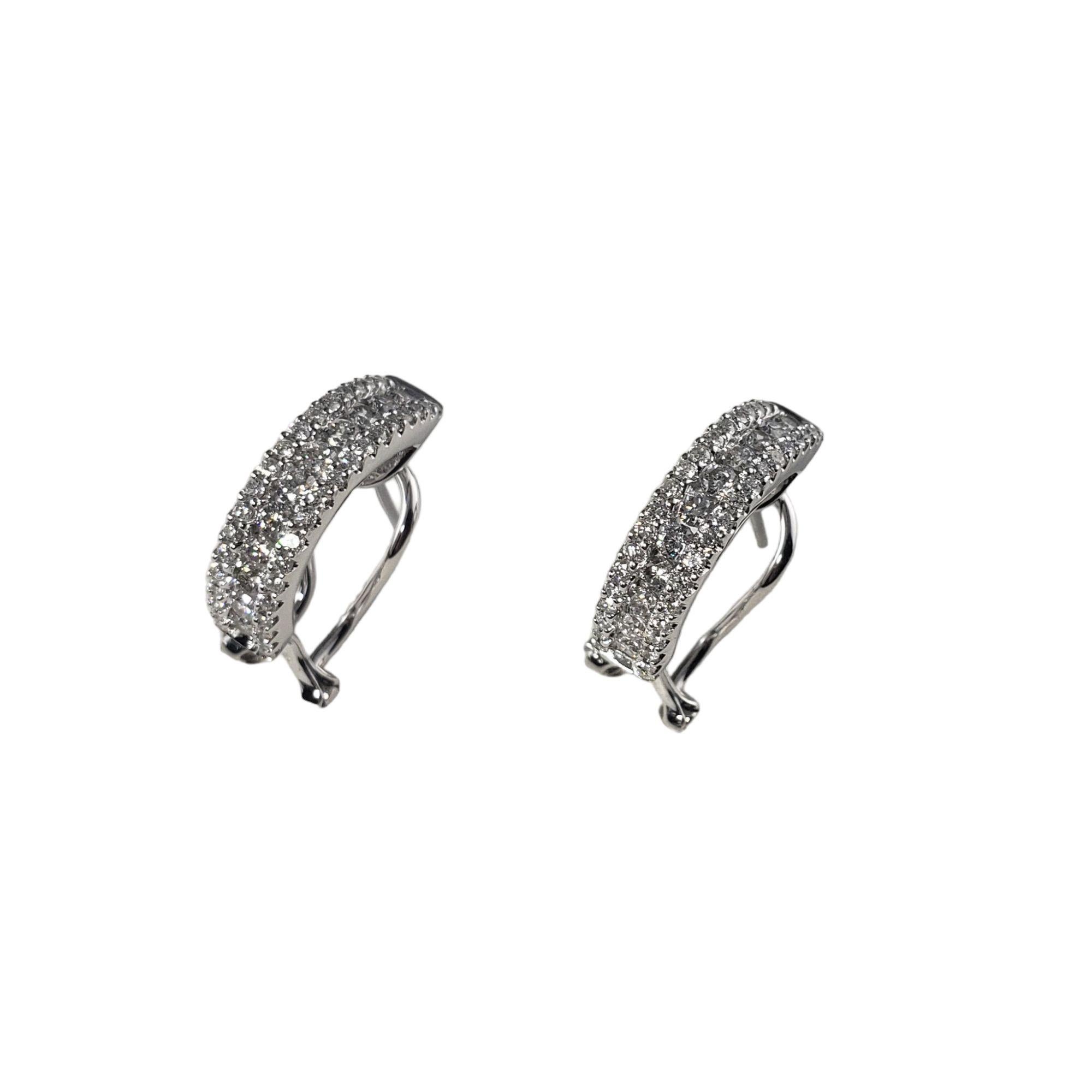 Vintage 18 Karat White Gold and Diamond Earrings-

These sparkling diamond earrings each feature 49 round brilliant cut diamonds set in classic 18K white gold. Width: 5 mm.
Omega back closures.

Total diamond weight: 1.42 ct.

Diamond color: