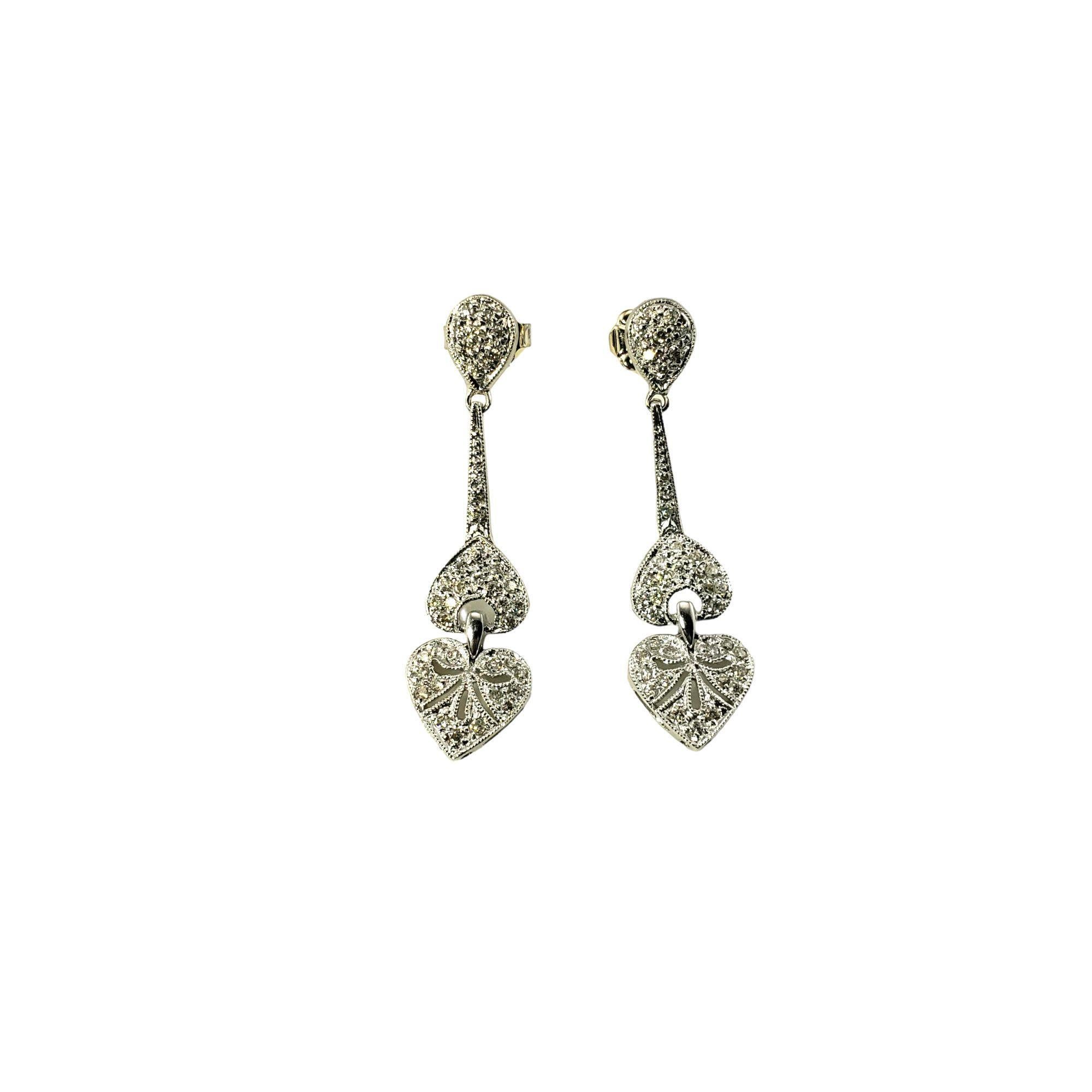18 Karat White Gold and Diamond Heart Dangle Earrings-

These sparkling dangling heart earrings each feature 40 round brilliant cut diamonds set in classic 18K white gold. Push back closures.

Approximate total diamond weight: .40 ct.

Diamond