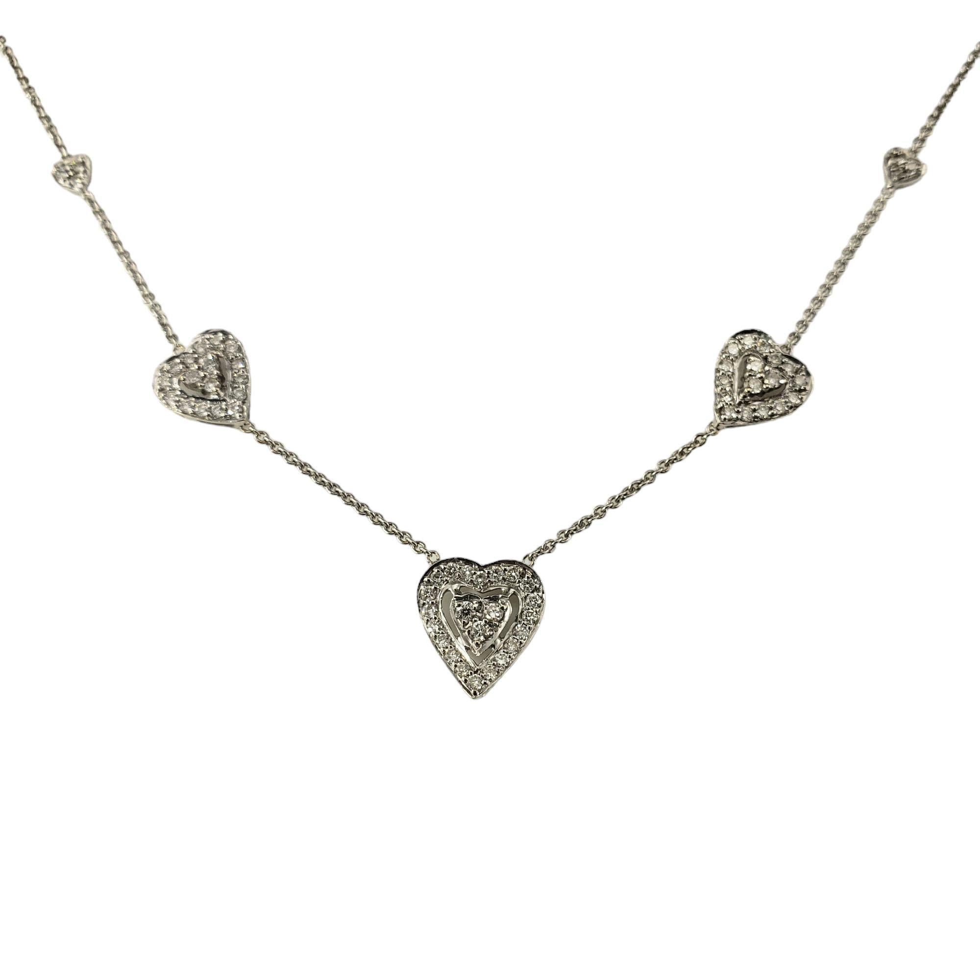 18 Karat White Gold and Diamond Heart Station Necklace-

This sparkling 18K white gold station necklace features seven hearts accented with 69 round brilliant cut diamonds.  

Center heart measures 11.5 mm x 10 mm.

Approximate total diamond