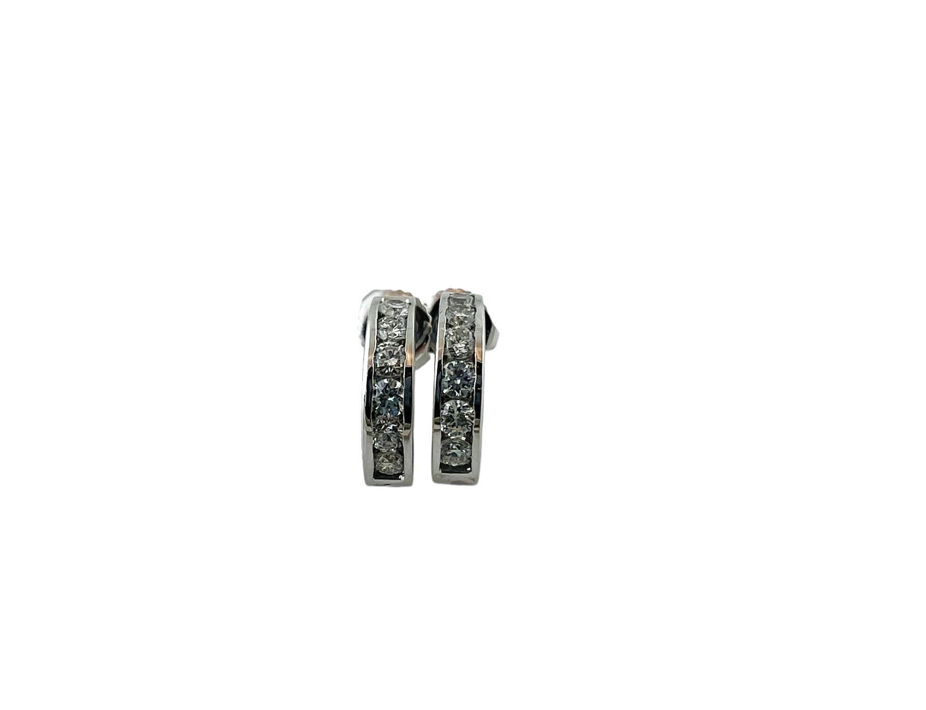Vintage 18 Karat White Gold and Diamond Hoop Earrings-

These sparkling hoop earrings each feature six round brilliant cut diamonds set in classic 18K white gold.  Push back closures.

Width:  3 mm.

Approximate total diamond weight:  .60