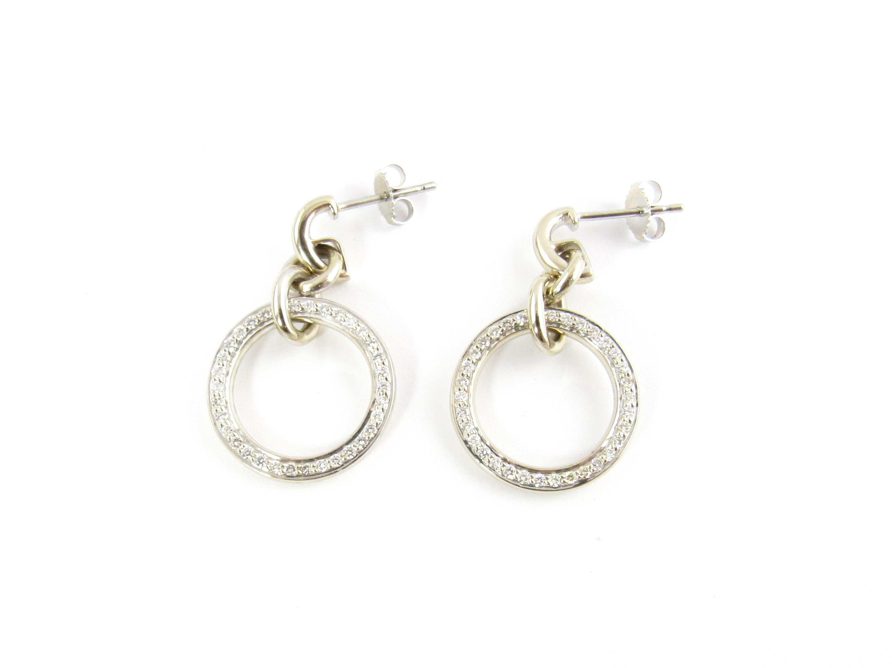 Vintage 18 Karat White Gold and Diamond Earrings

These stunning dangling hoop earrings each feature 34 round brilliant cut diamond set in beautifully detailed 18K white gold. Push back closures. (Earring backs are 14K).

Approximate total diamond