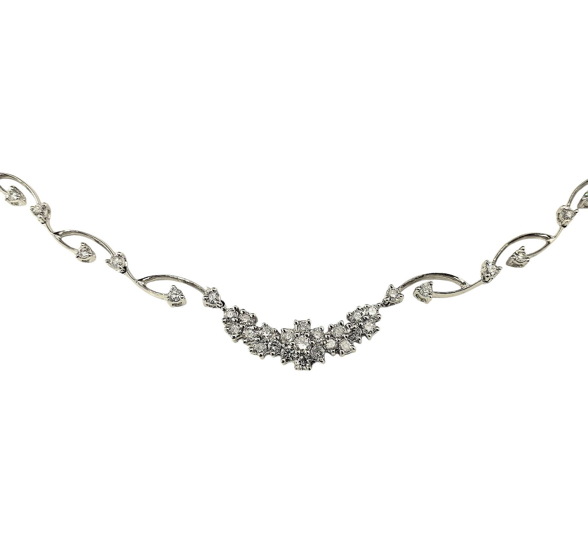 18 Karat White Gold and Diamond Necklace

Graceful and timeless, this stunning necklace is crafted in 18K white gold and adorned with 35 round brilliant cut diamonds. The design features a series of delicate, curved links accented with prong-set