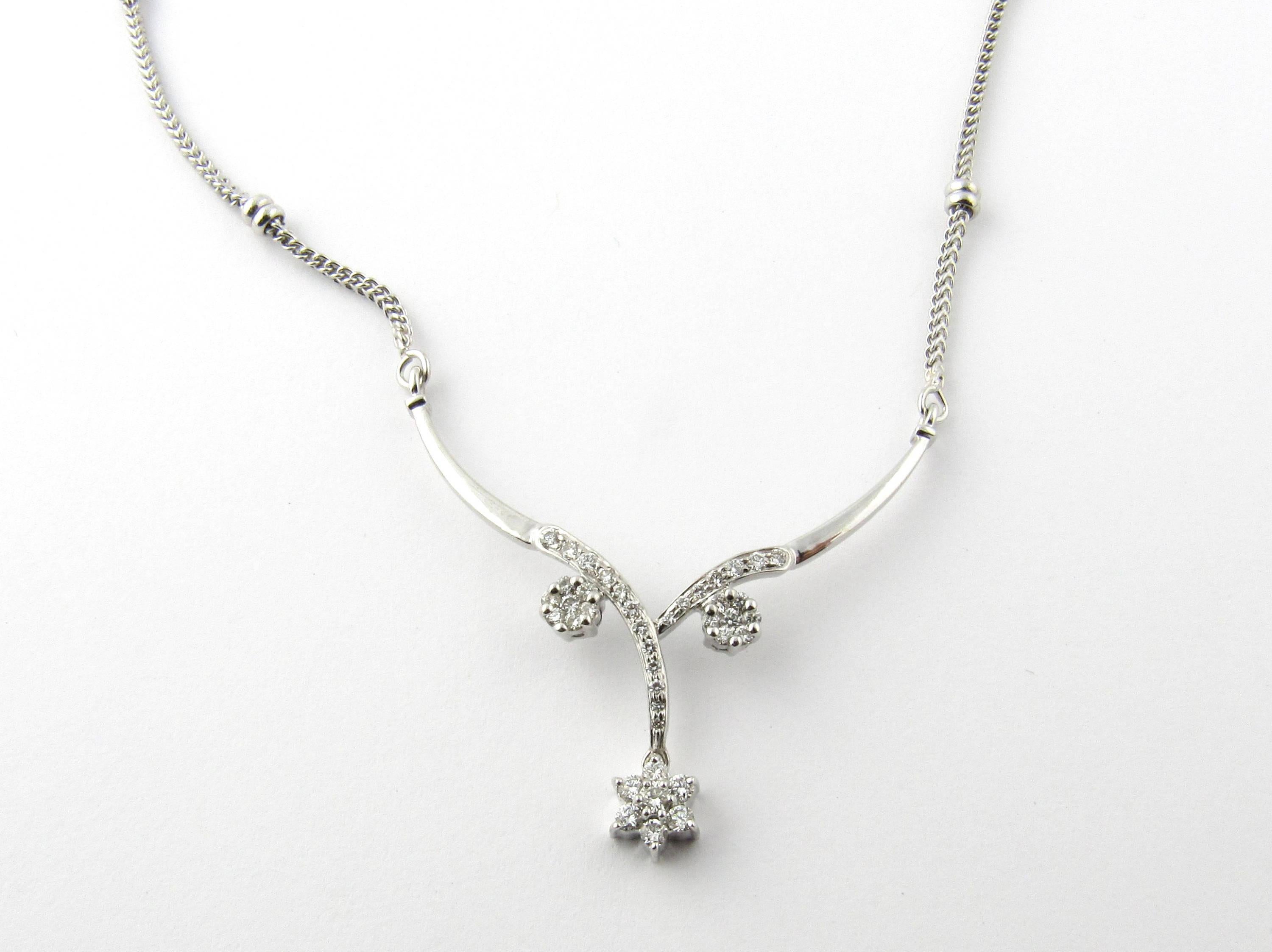 Vintage 18 Karat White Gold and Diamond Necklace- 
This elegant necklace features 40 round brilliant cut diamonds in a lovely flower design on a white gold beaded chain. Approximate total diamond weight: .40 ct. Diamond clarity: SI2 Diamond color: