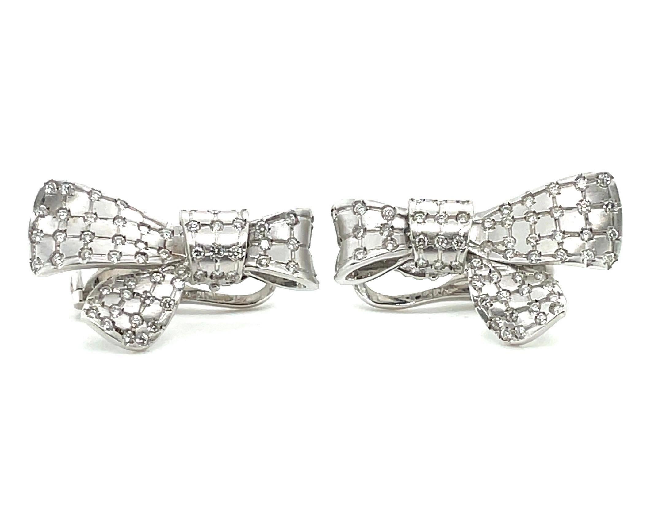Attractive pair of 18 karat white gold and diamond ribbon bow earclips. 

Charming earclips crafted in 18 karat white gold, each designed as a sculpted ribbon bow with matte-finish, checkered surface and decorated with 134 brilliant-cut diamonds