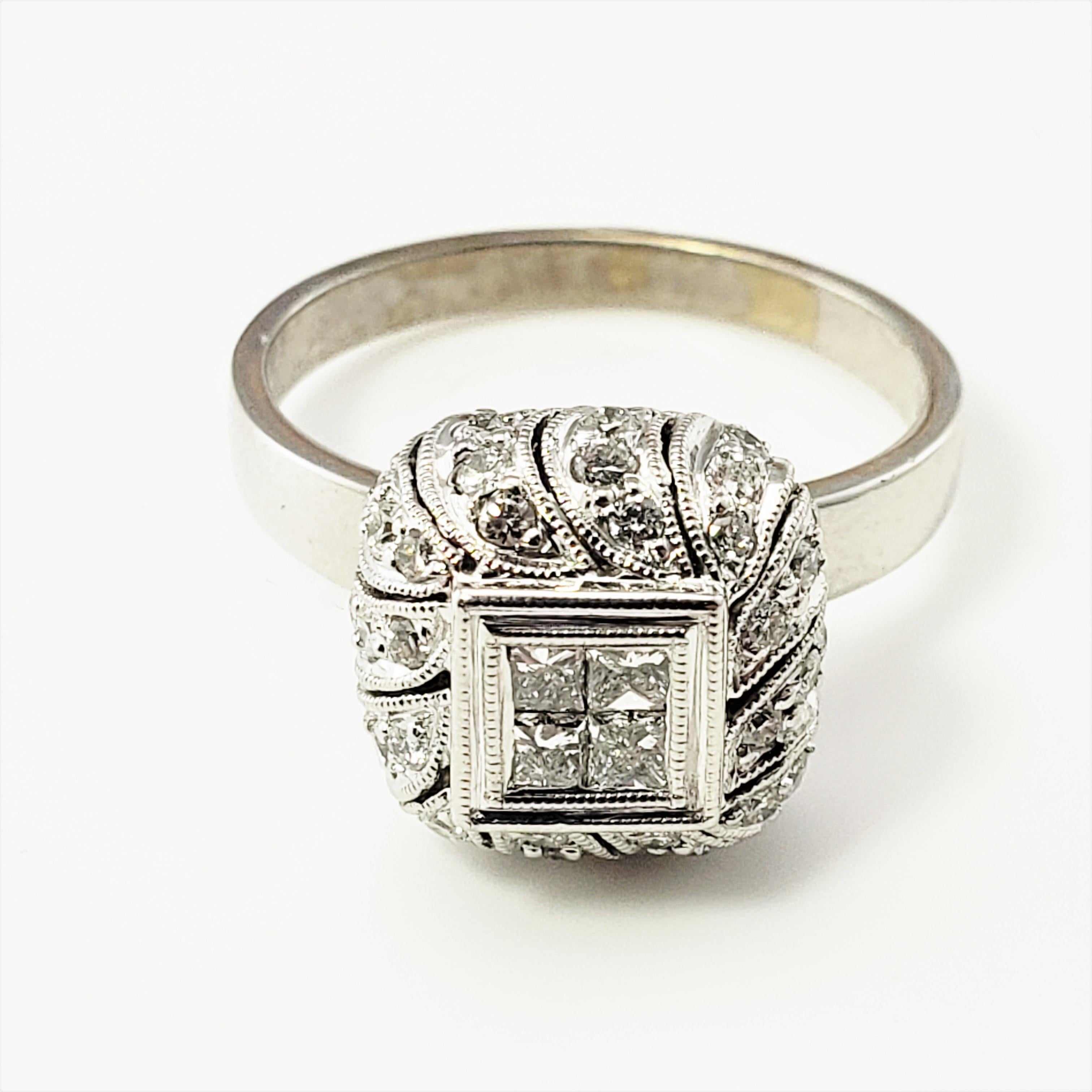 18 Karat White Gold and Diamond Ring Size 7 -

This stunning ring features four princess cut diamonds in its center (.05 ct. each) surrounded by 48 round brilliant cut diamonds and set in beautifully designed 18K white gold.  Width:  11 mm.  Shank: 