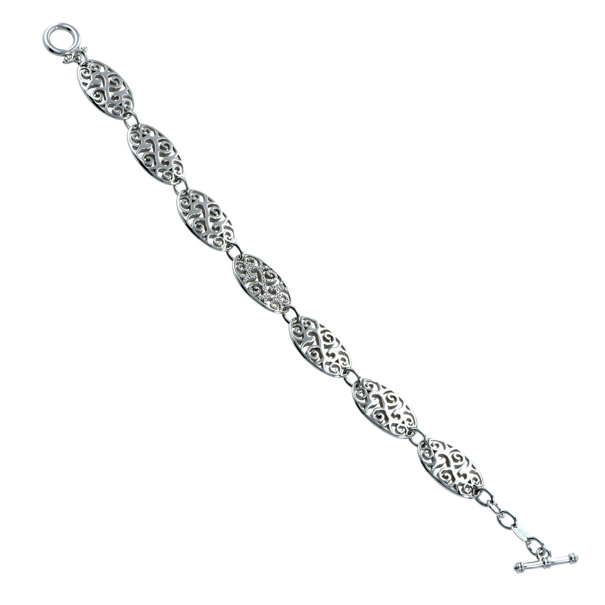 18k White Gold and Diamond Bracelet featuring 38 round brilliant cut diamonds weighing approximately .14 carats total weight, G color, VS clarity. Seven oval shaped links with a stunning swirl and swag motif make up this gorgeous bracelet. The