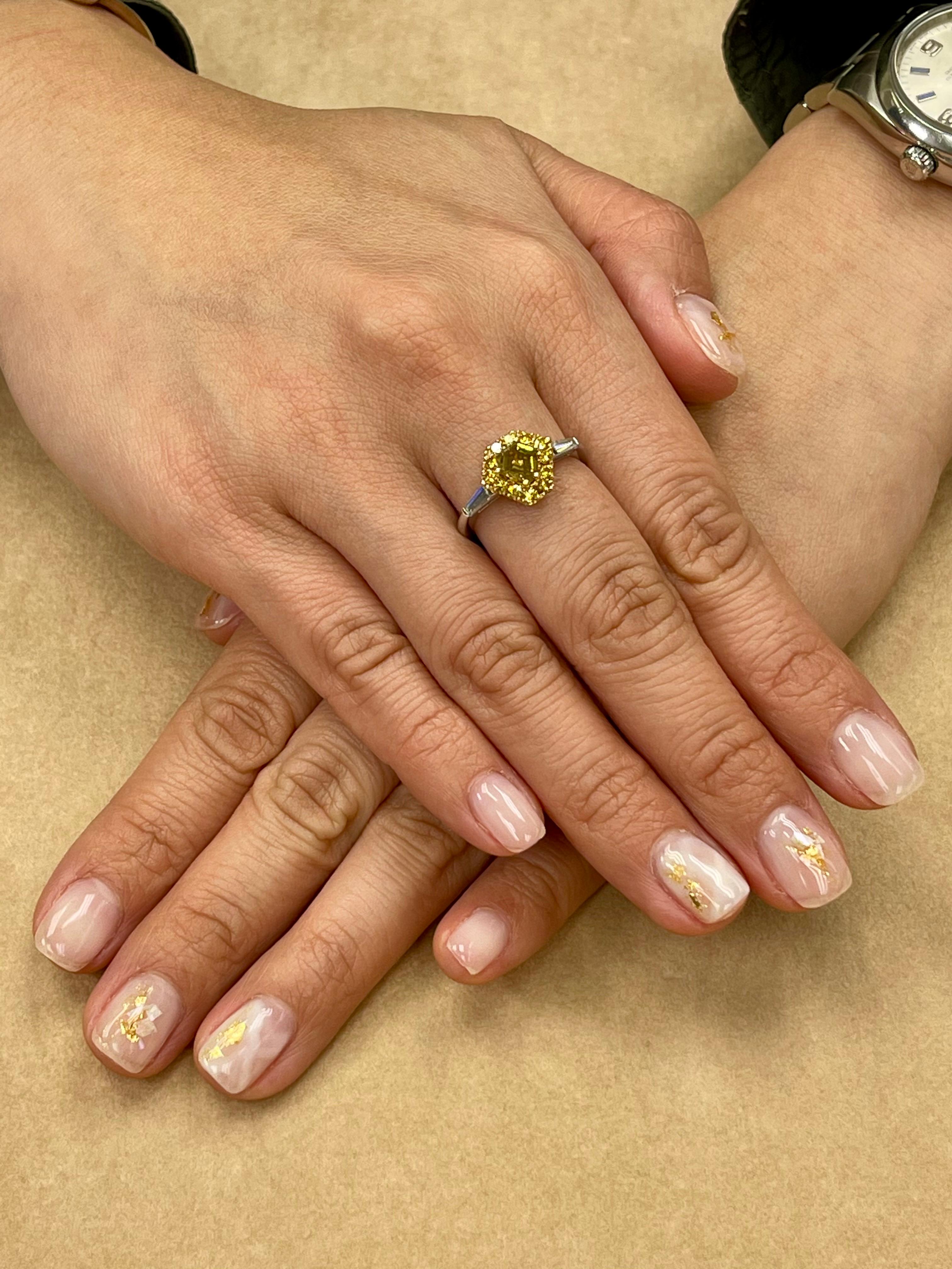 Please check out the HD video! Here is a unique ring made with rare and very colorful natural diamonds! This cocktail ring is set in 18k white gold, a shield or kite step cut natural fancy vivid yellow diamond as the center diamond. Surrounding the