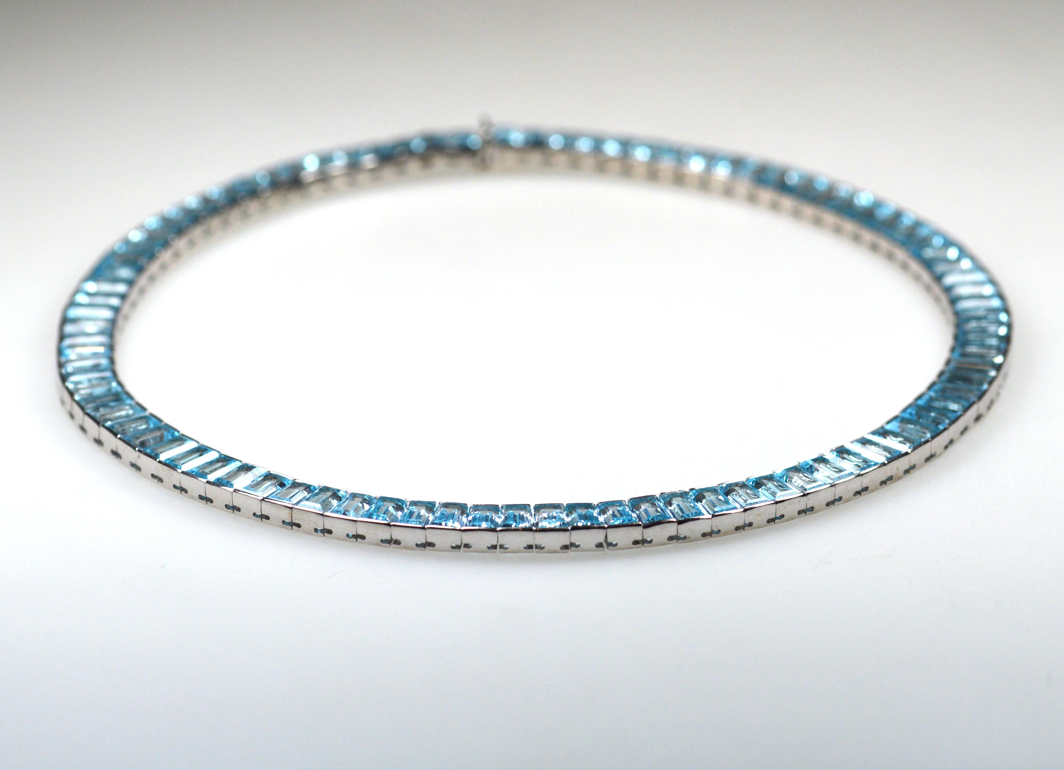 Striking 18 karat white gold and topaz necklace.

This elegant eye-catching necklace is designed as a line of finely matched topaz baguettes totalling circa 115 carats within a white gold channel setting.
This wonderful jewel has been recently