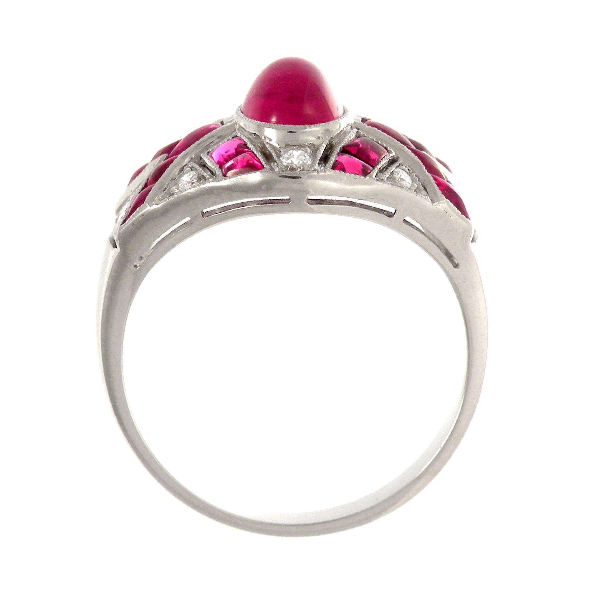 This is a fantastic Art Deco ruby and diamond Antique dinner ring which features a beautiful eye clean ruby weighing 1.70 cts. The mounting, which is crafted in 18K white gold, features a geometric line design buff-top ruby weighing 3.02 cts. 