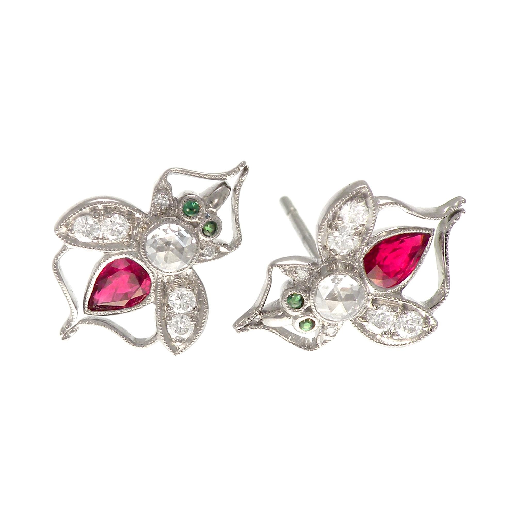 
An antique style bee brooch stud earrings drawing inspiration from the Victorian insect jewelry beloved by that generation's interest in the natural world. The bee is set with rich red faceted ruby for the body and cabochon green garnet eyes of the