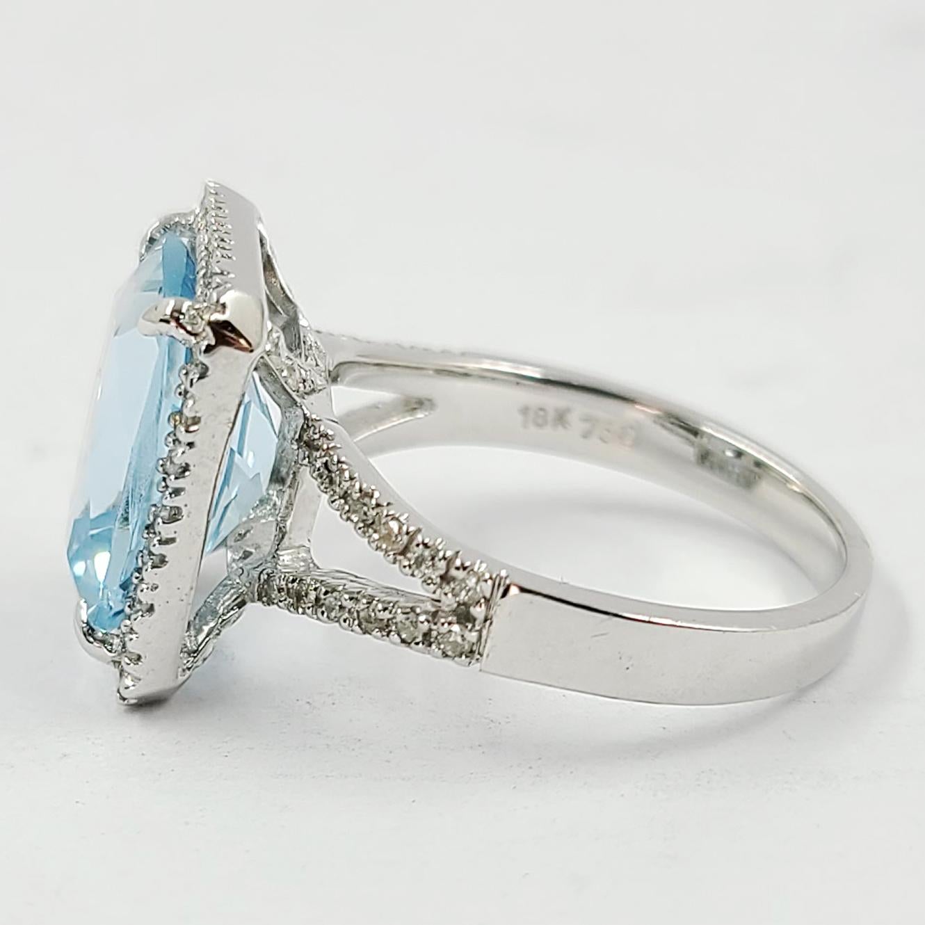 18 Karat White Gold Cocktail Ring Featuring A Cushion Cut Aquamarine Weighing Approximately 5.00 Carats Surrounded By 55 Round Diamonds Of VS Clarity & G/H Color Totaling 0.30 Carats. Split Shank Design. Finished Weight is 6 Grams. Current Finger