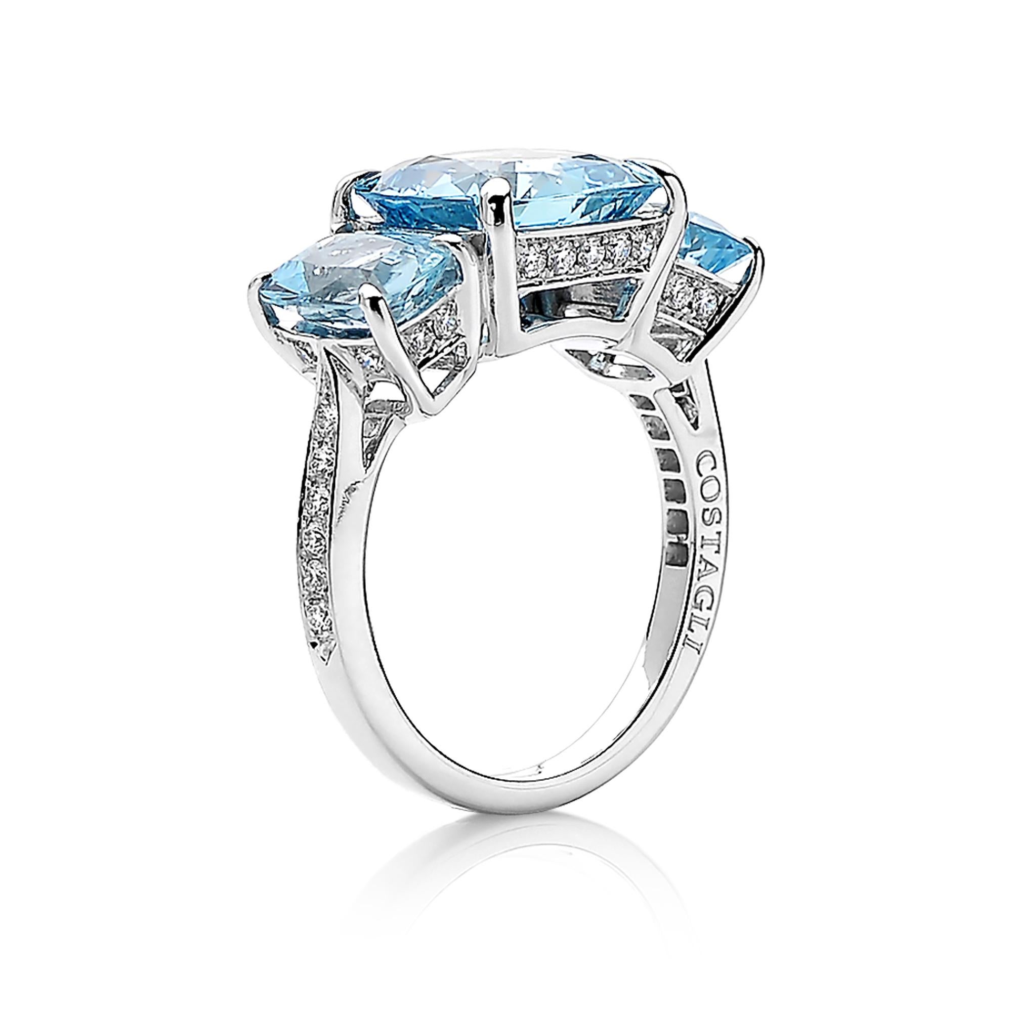 One of a kind cushion-shape aquamarine three stone ring set in 18k white gold with pave-set round, brilliant diamond detailing.

A classic silhouette for ideal cushion cut aquamarines, allowing the ring to feel substantial as the setting covers the