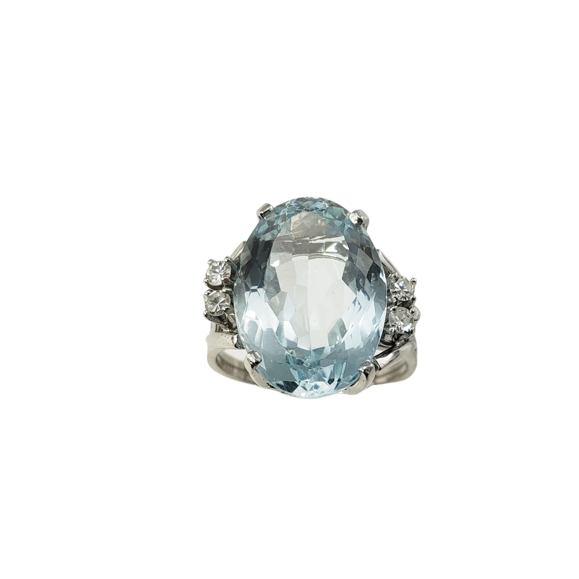 18 Karat White Gold Aquamarine and Diamond Ring Size 5.75 GAI Certified:

This stunning ring features one oval aquamarine (16 mm x 12 mm) and four round single cut diamonds set in classic 18K white gold.  Shank:  2 mm.

Aquamarine weight:  10.83