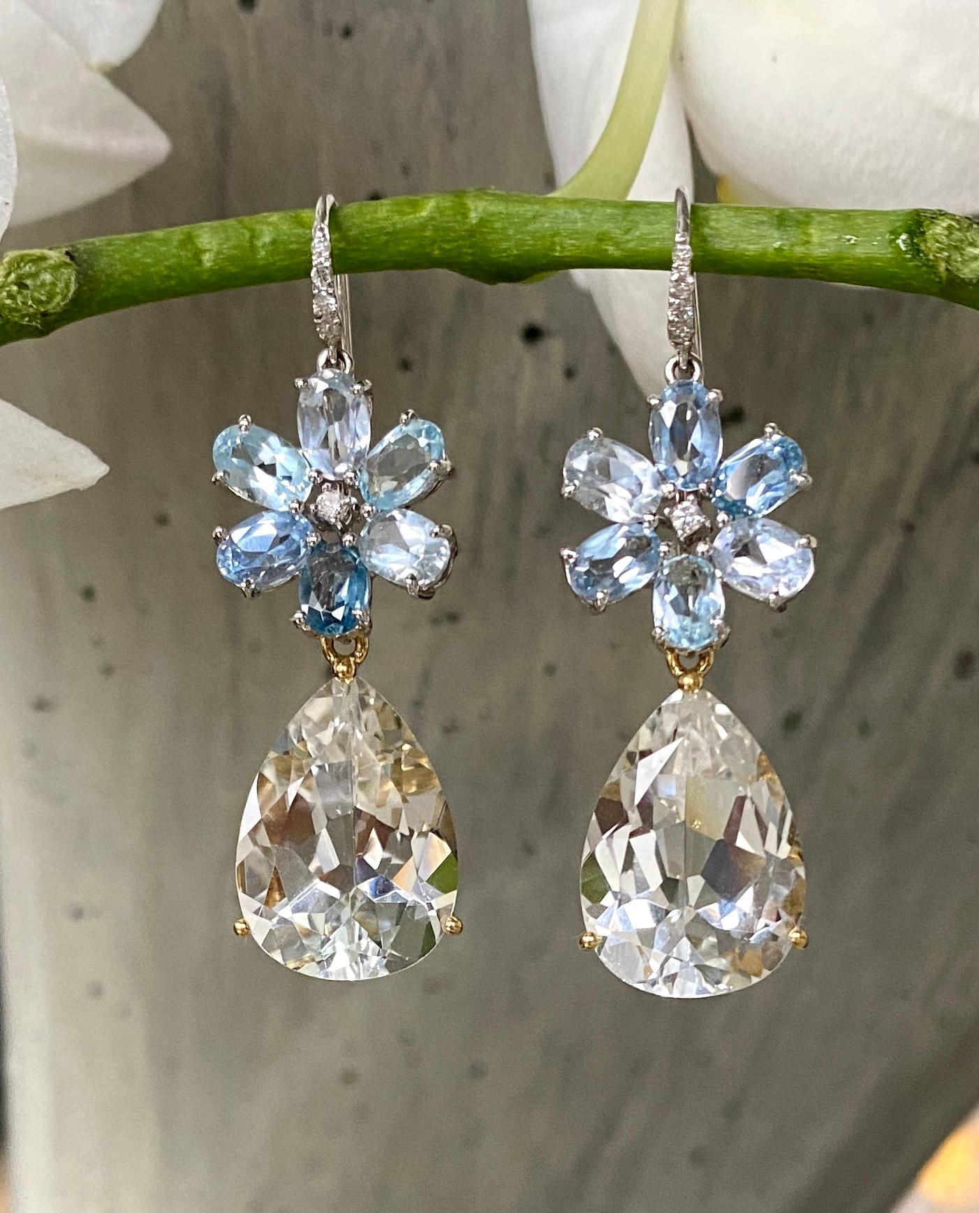 Earrings of aquamarine and diamond flowers with detachable pear shape white topaz drops, handcrafted in 18 Karat white gold.

These exquisite earrings of aquamarines and diamonds with detachable white topaz drops are a modern take on a classic look.