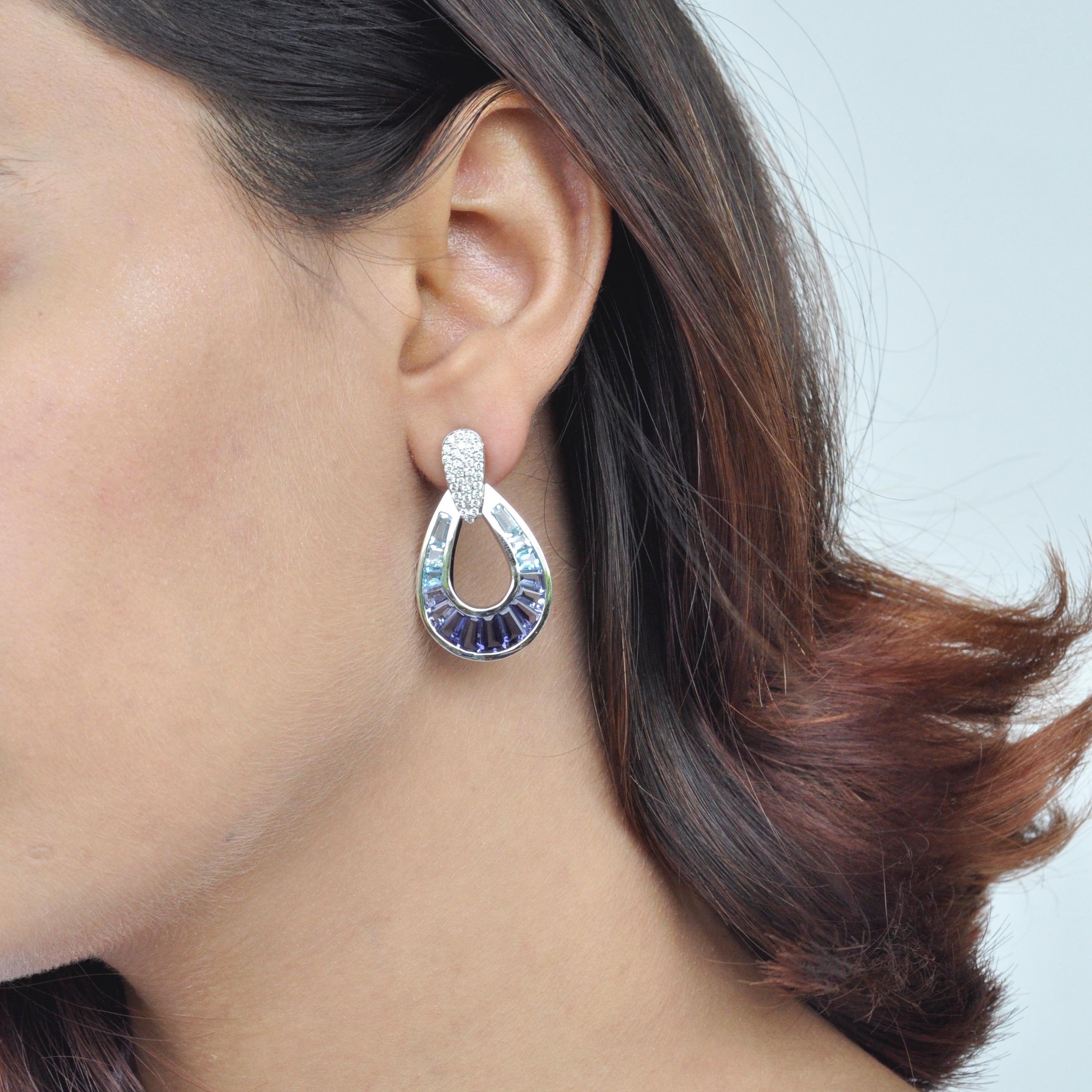 Art, color and culture all come together to inspire this Côte d'Azur 18 karat white gold aquamarine, iolite, blue topaz baguette and diamond raindrop earrings, where the cool shades of aquamarine, iolite and blue topaz captures the mood of the
