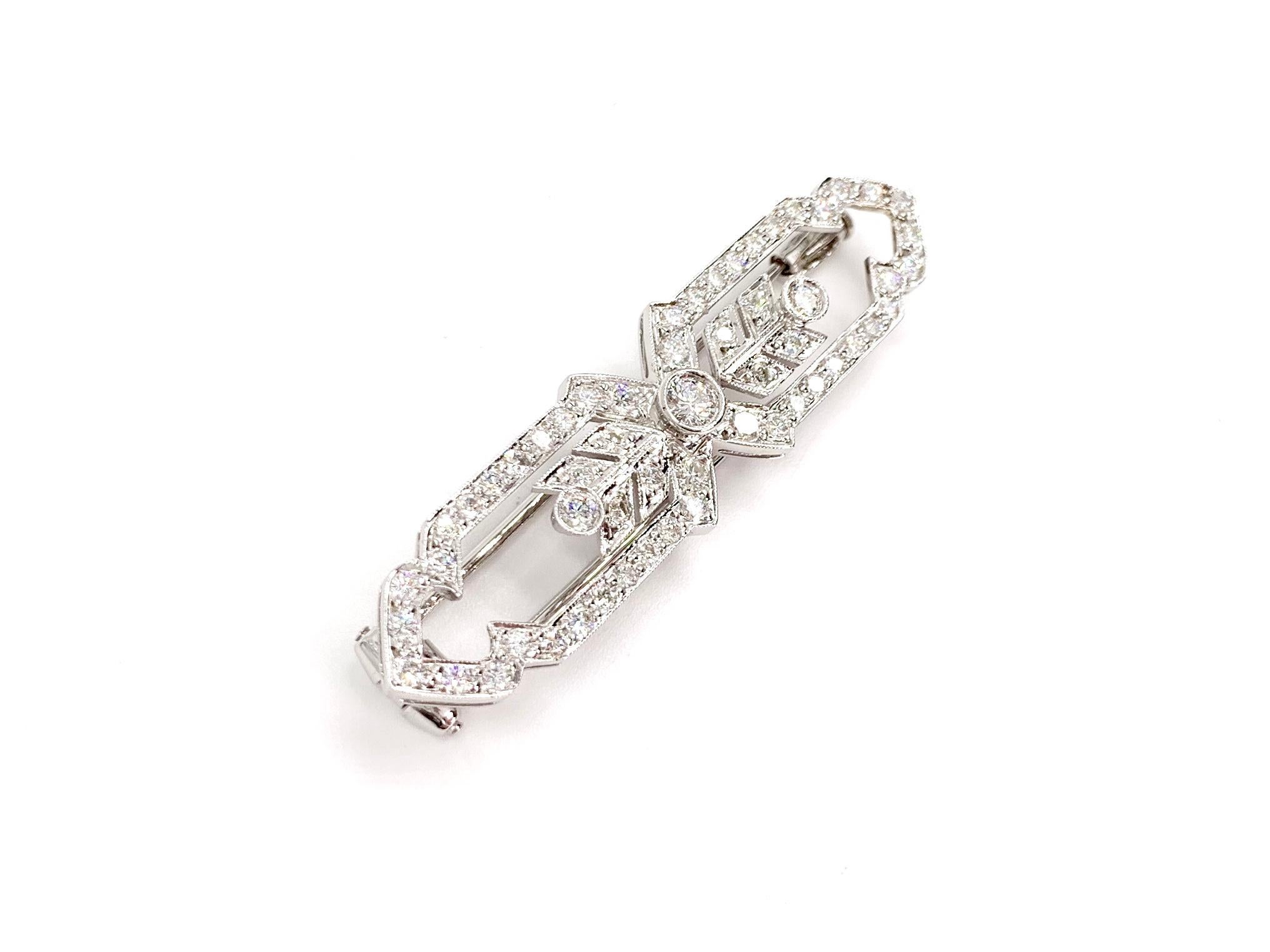 A beautiful Art Deco inspired 18 karat white gold and modern round brilliant diamond arrow motif brooch pin featuring approximately .90 carats of diamonds. Diamond quality is approximately G color, SI1 clarity. Pin is very well made with a double