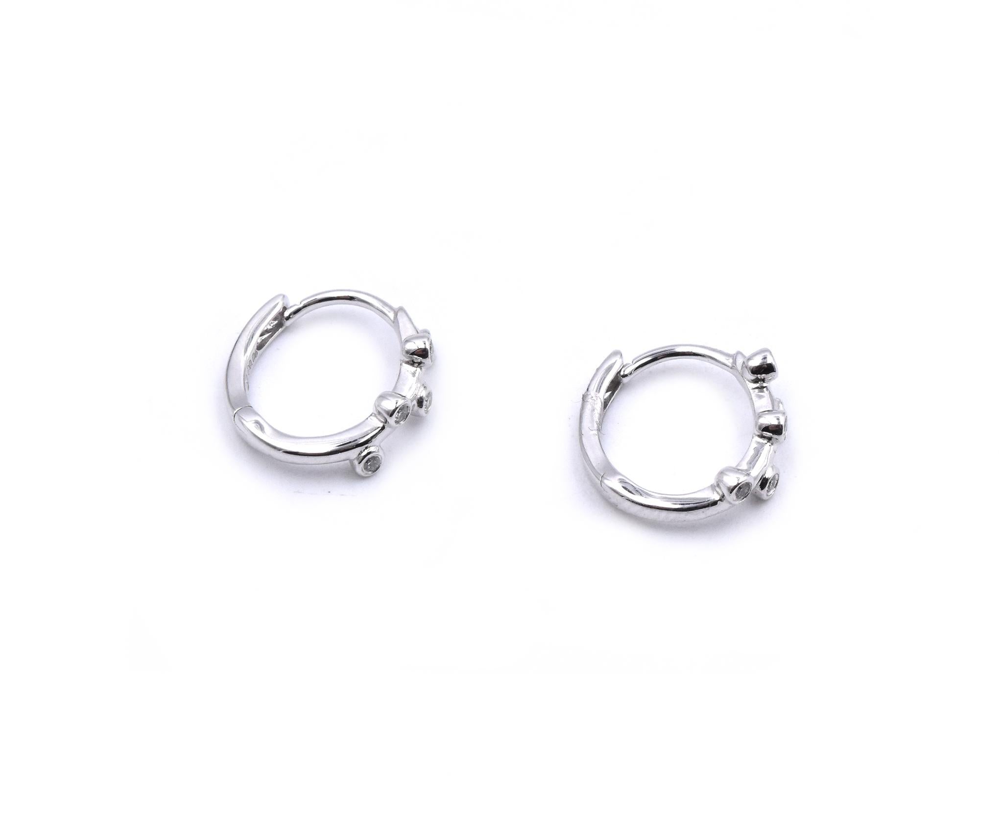 Material: 18K white gold
Diamonds: 10 round cut = .06cttw
Color: G
Clarity: VS
Dimensions: earrings measure 11.9 X 3.75mm
Fastenings: snap closure
Weight: 1.73 grams
