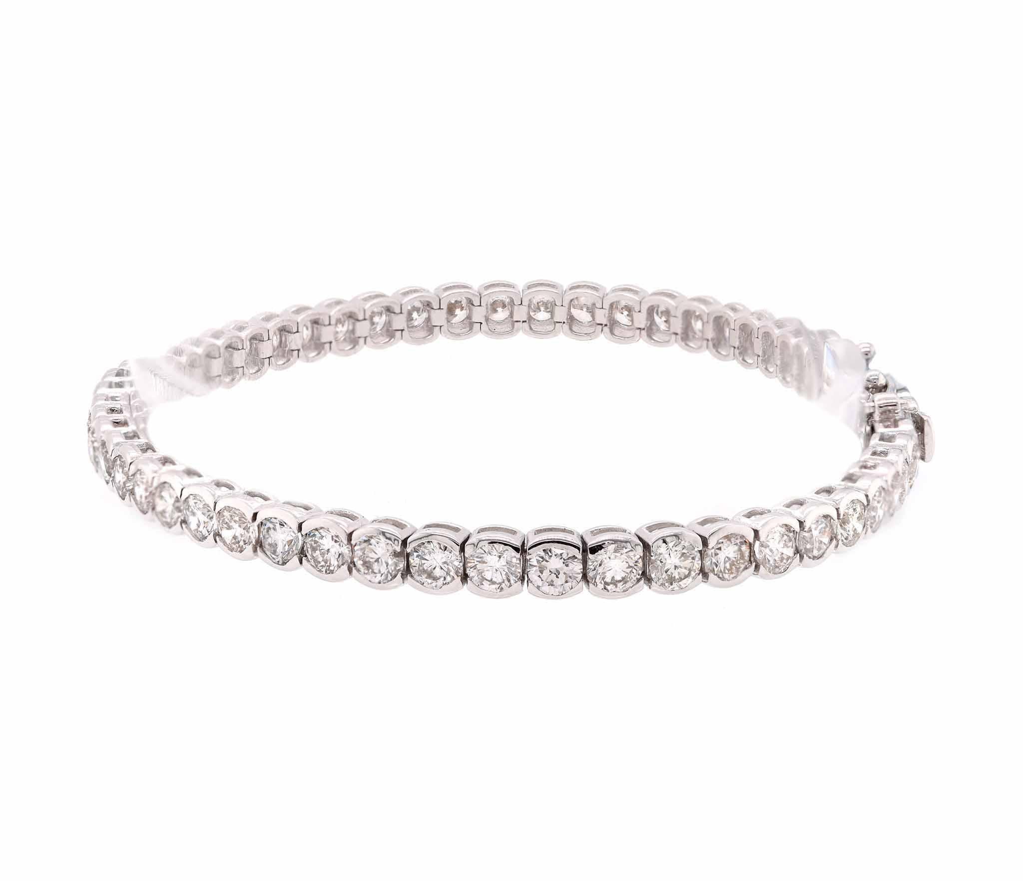 Designer: custom designed 
Material: 18K white gold
Diamonds: 55 round cut = 6.18cttw
Color: G
Clarity: VS2-SI1
Dimensions: bracelet will fit a 7-inch wrist 
Weight:  11.26 grams
