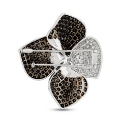18 Karat White Gold Black and White Diamond Flower Swirl Pin