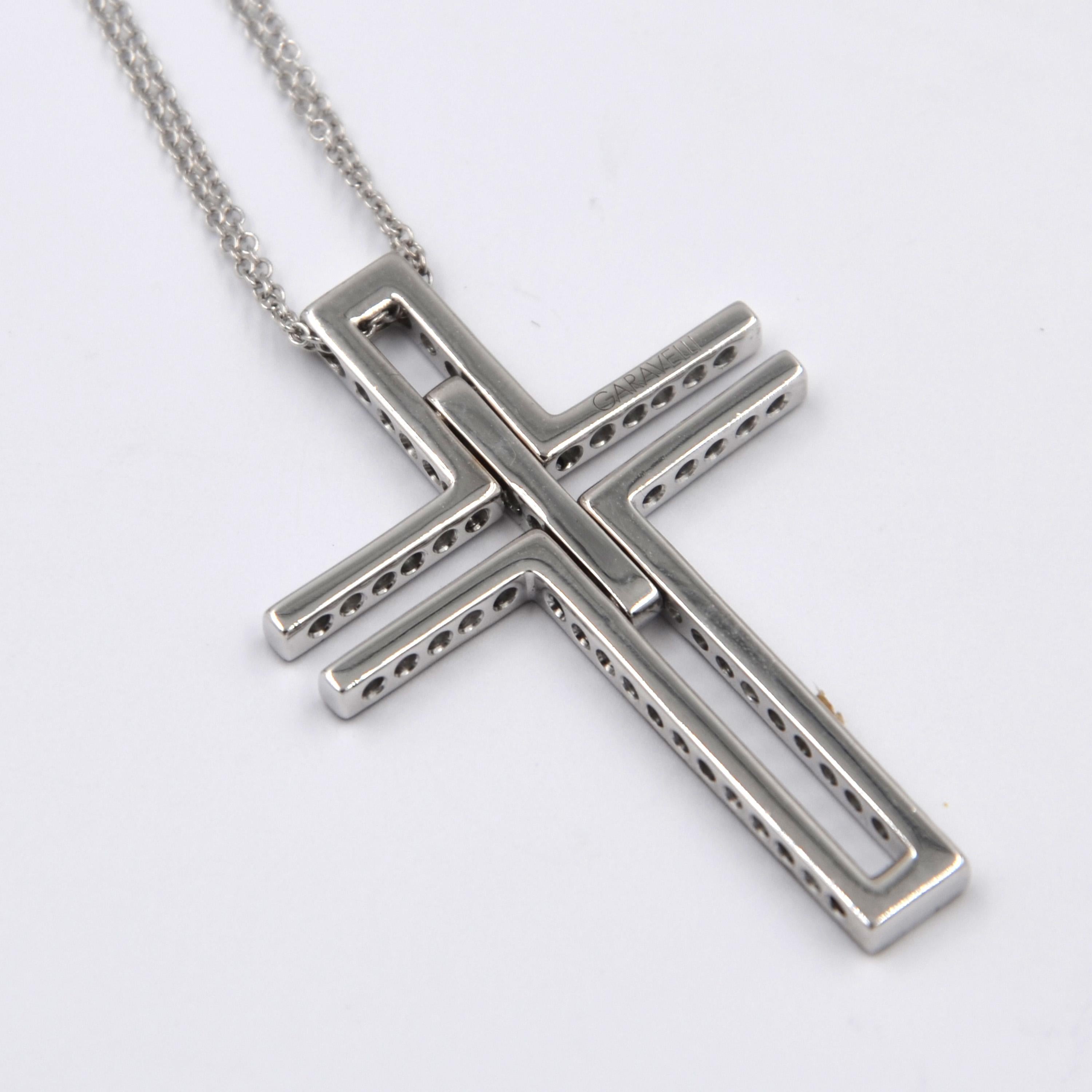 18KT White Gold Flexible Cross Pendant with Chain set with black and white diamonds. Made in Italy by Garavelli  
 
Pendant size mm 38 lenght and 25 width.
 Chain total lenght cm 50 with a loop at 40 cm
18kt GOLD gr : 9.80
BLACK DIAMONDS ct