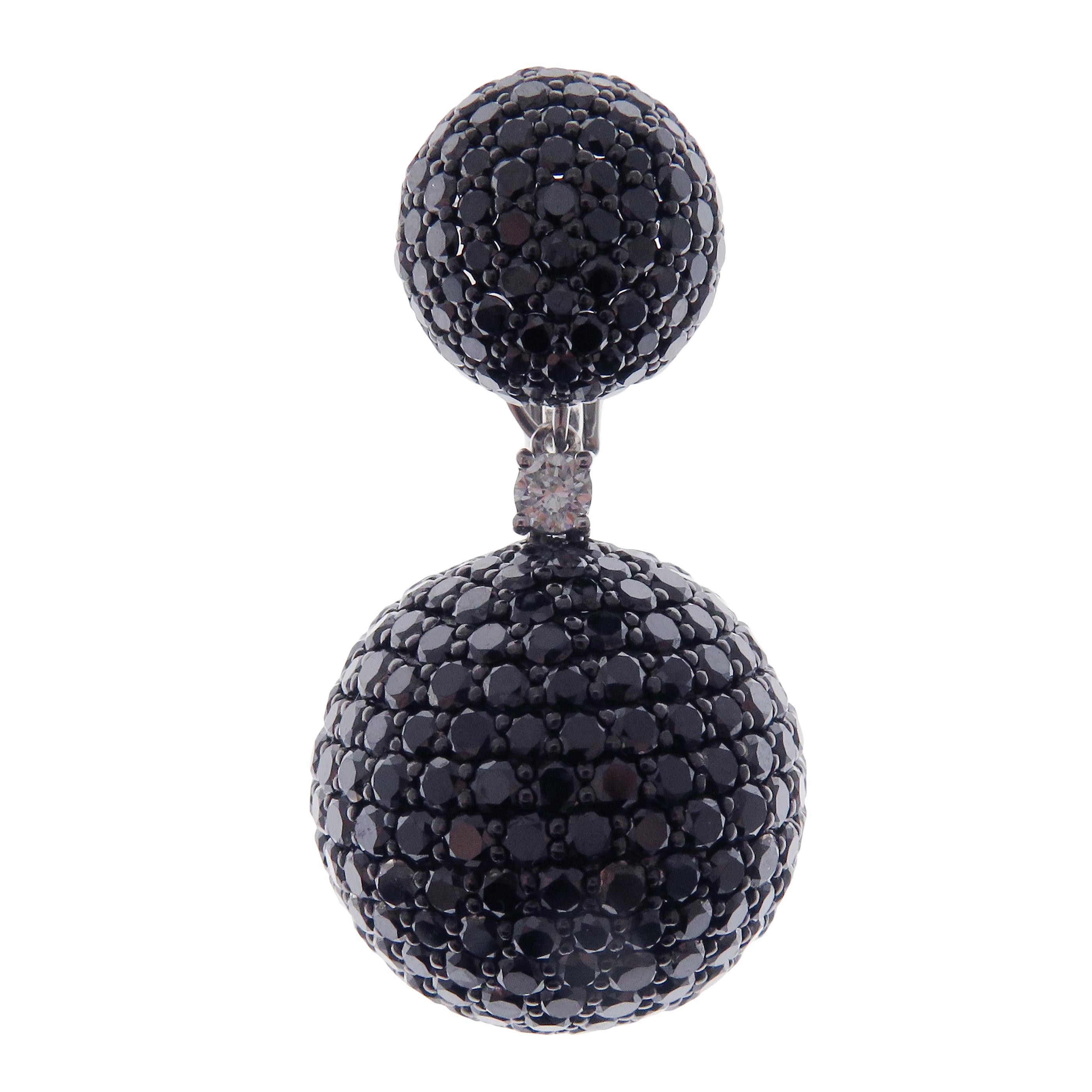 These ball pave earrings are crafted in 18-karat white gold, weighing approximately 31.80 carats of Black diamond with 786 round diamonds. French clip backing on top. 

Beautiful 0.15 pt white diamond accent on each earring and multi-functional