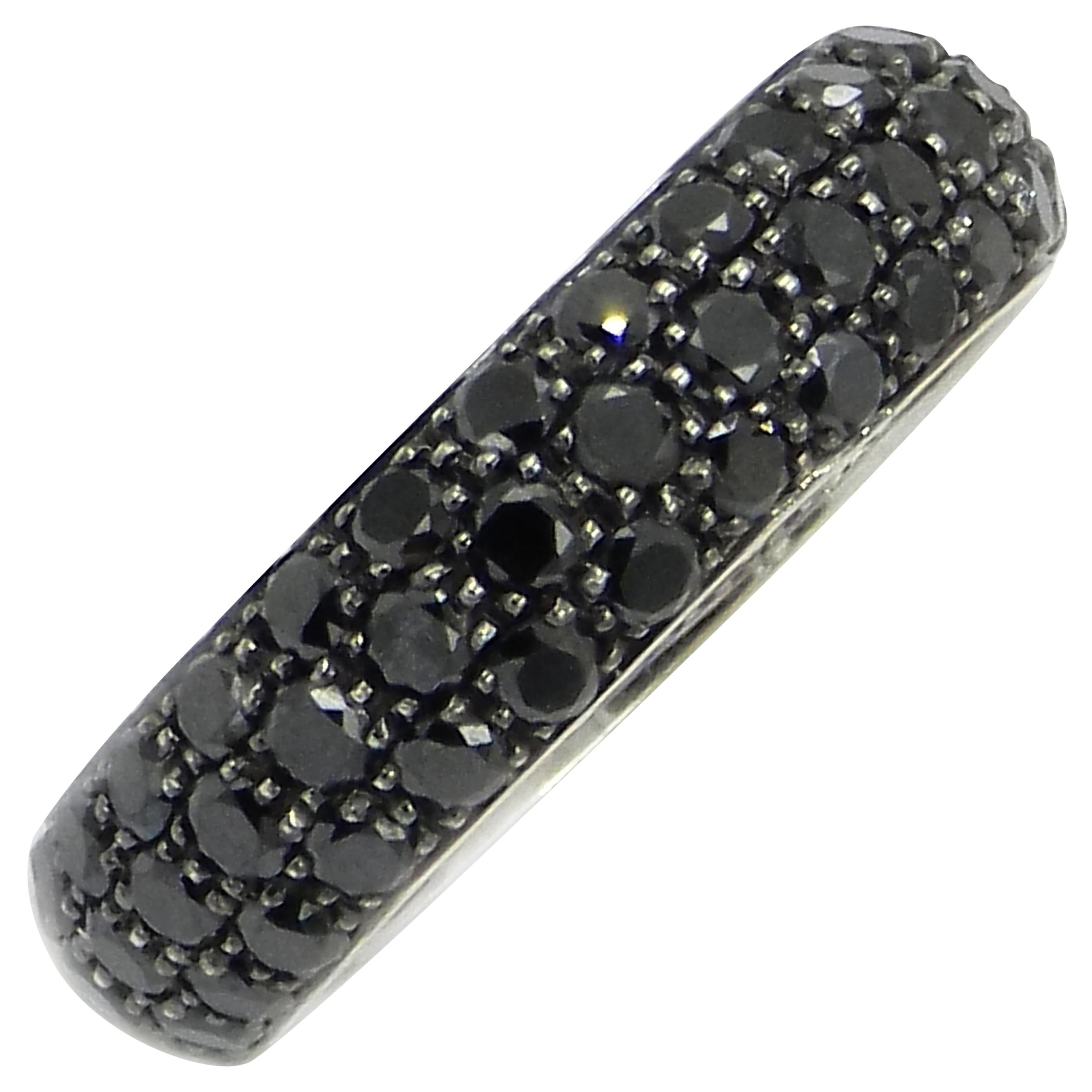A beautiful piece of jewelry from Garavelli,  an Eternity ring. 
Brand: Garavelli
Material: 18 Karat White Gold
Diamonds: Black Diamonds in Pavé Band Eternity Style
Total Carat Weight: 2.88
Setting: Three rows of black diamonds
Ring Style: Eternity