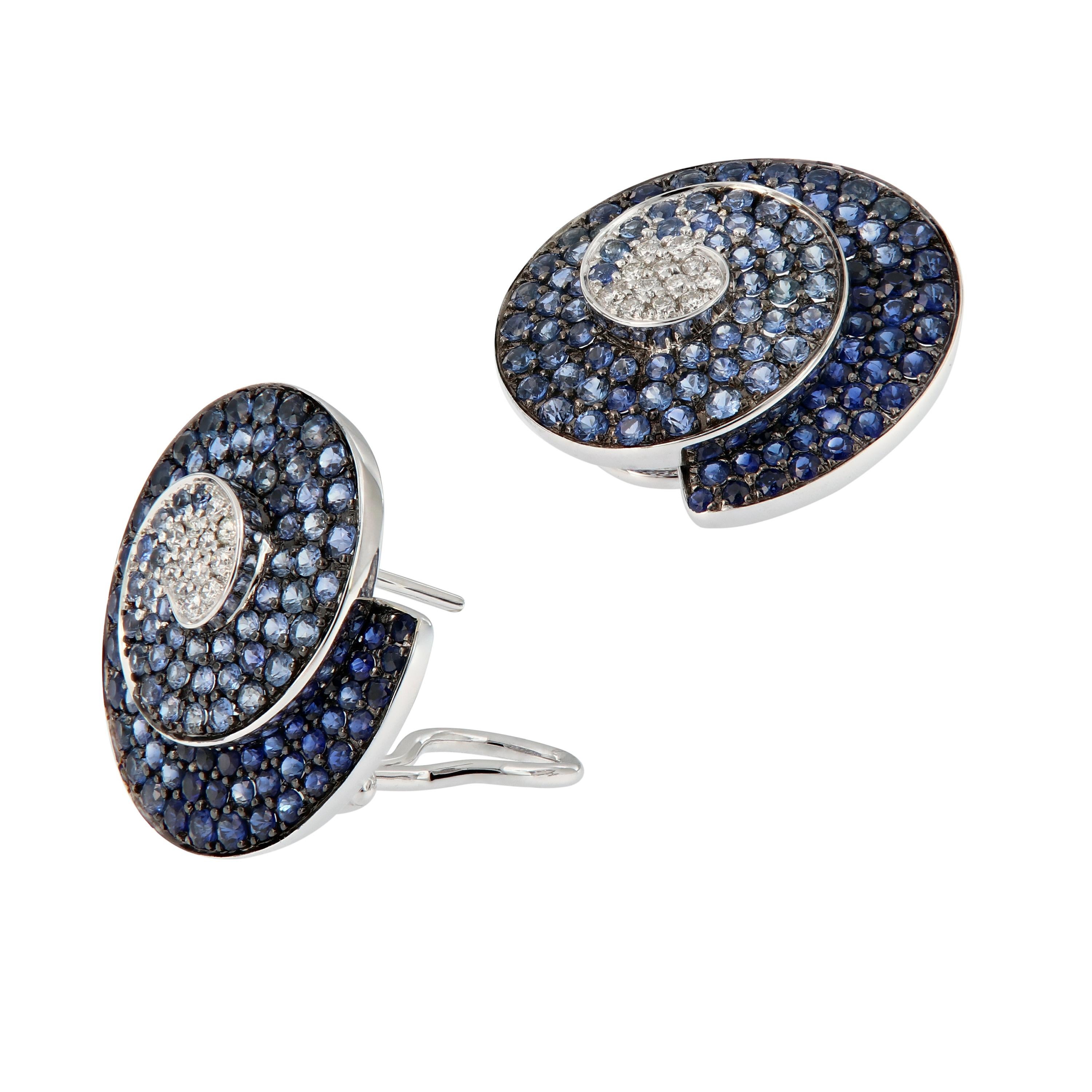 These elegant earrings each feature a swirl design of graduating shades of blue sapphires and white diamonds, creating a beautiful ombre effect. Earrings are crafted in 18k white gold with black rhodium overlay. 

Sapphires 1.18 cttw
DK Sapphires