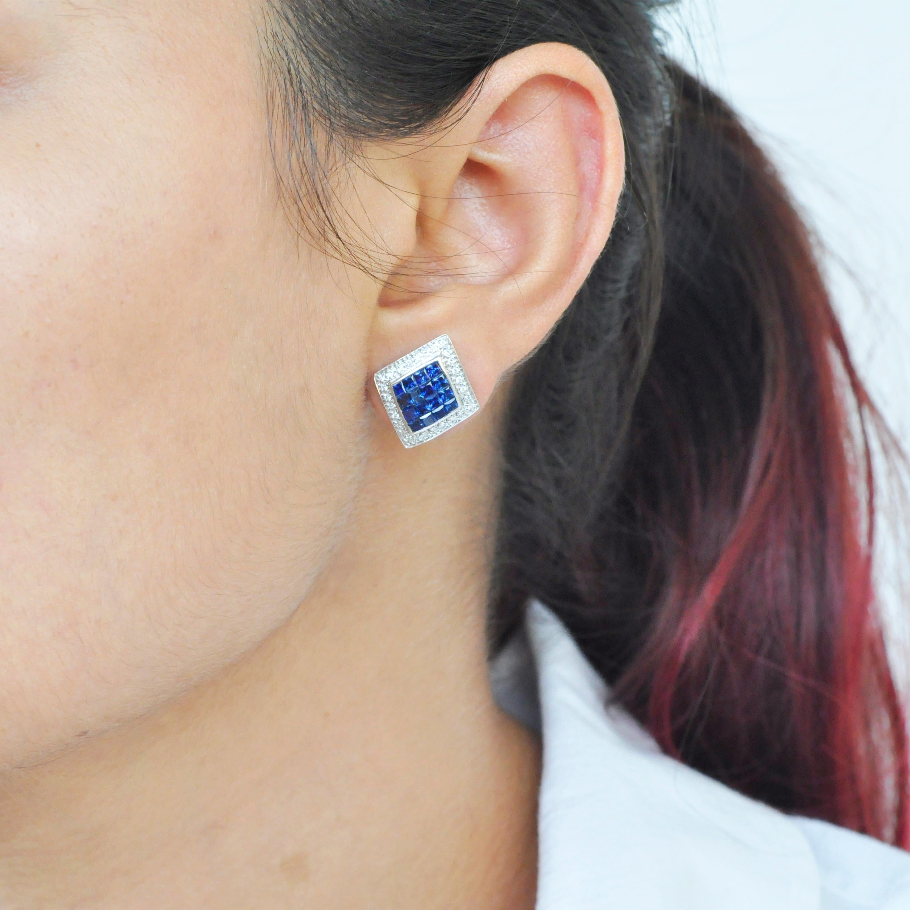 18 karat white gold invisible setting 5.76 carats sapphire diamond stud earrings.

This incredible royal blue sapphire and diamond stud earring is mesmerizing. The impressive no metal setting of the three perfect rows of princess cut sapphires
