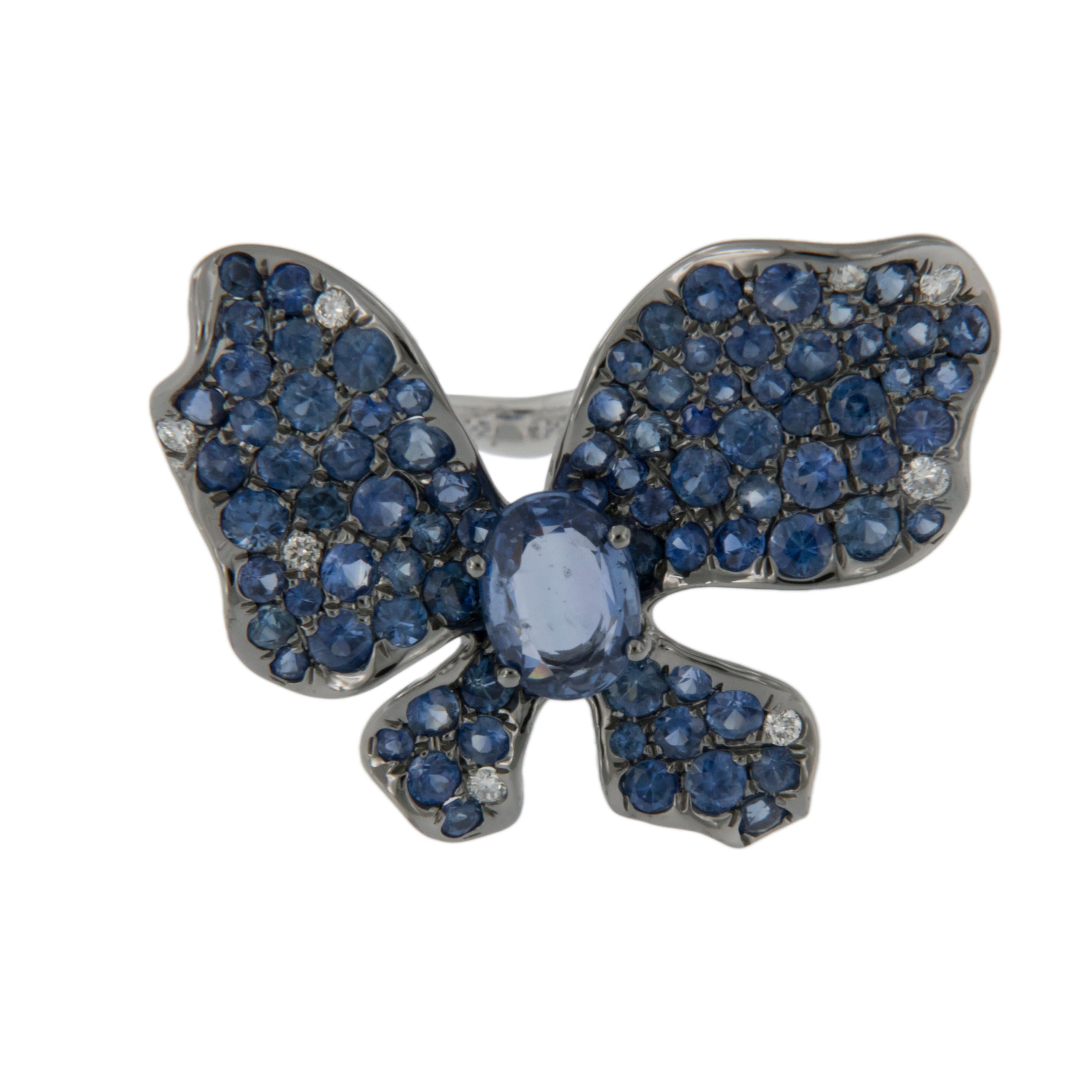 This fluid and whimsical ring is simply elegant! With 1.86 Cttw various tones of fine blue sapphires accented by 0.04 Cttw white diamonds, you will be elated wearing it. Ring is a size 6.75, but can be size to fit most. Complimentary signature