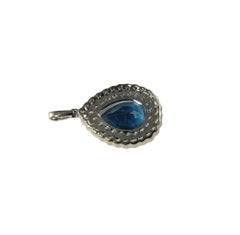 18 Karat White Gold Blue Topaz and White and Champagne Diamond Pendant