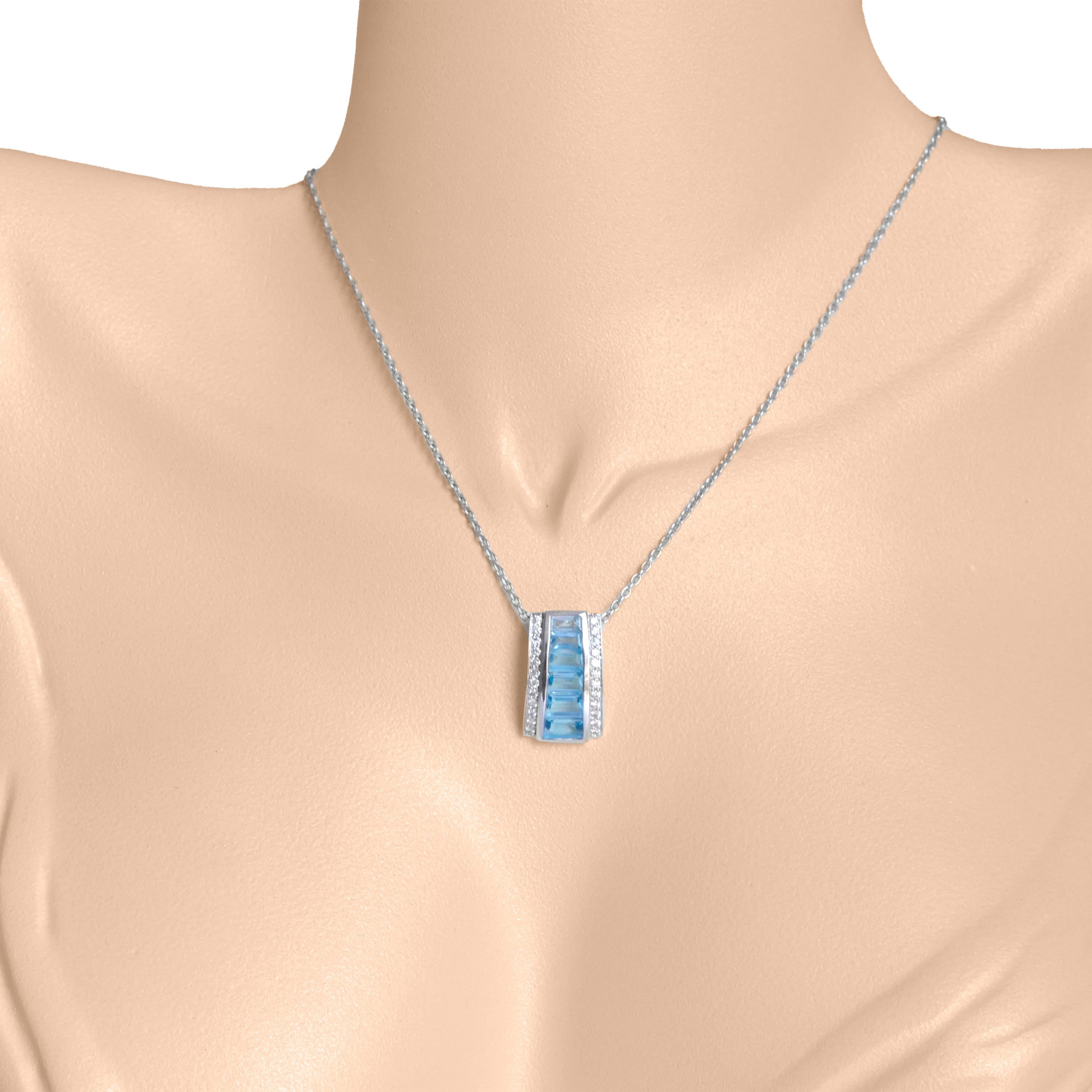 Introducing our exquisite 18K Gold Blue Topaz Pyramid Diamond Pendant Necklace, a captivating fusion of elegance and brilliance. This necklace showcases a stunning pyramid-shaped pendant adorned with a mesmerizing channel-set blue topaz gemstones
