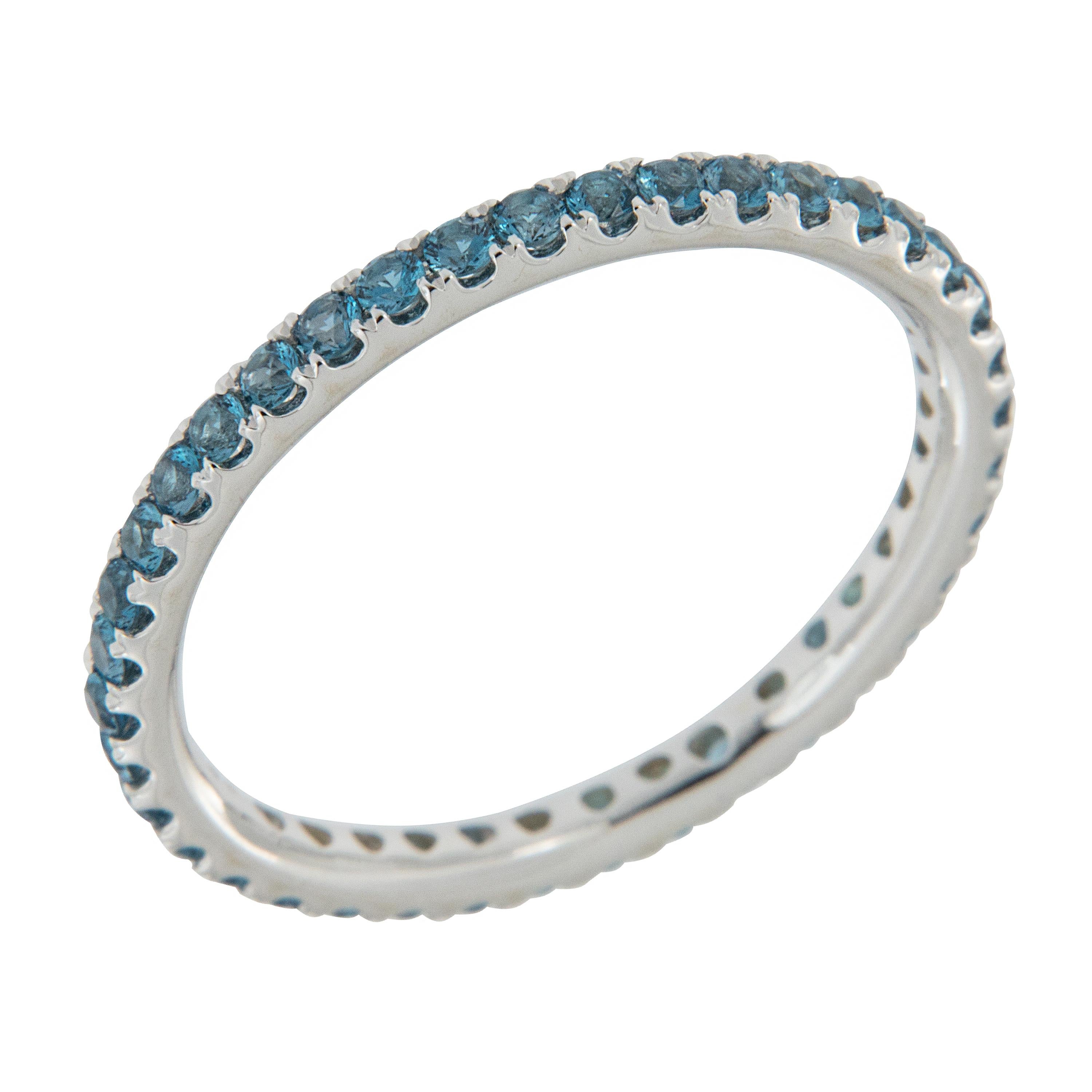 Soothing blue is this 18 karat white gold blue topaz eternity ring with 38 topaz = 1.20 Cttw in a size 6.00! Blue Topaz is a birthstone for December  and is the suggested anniversary gemstone for the 4th, 19th or 23rd year of marriage. This ring
