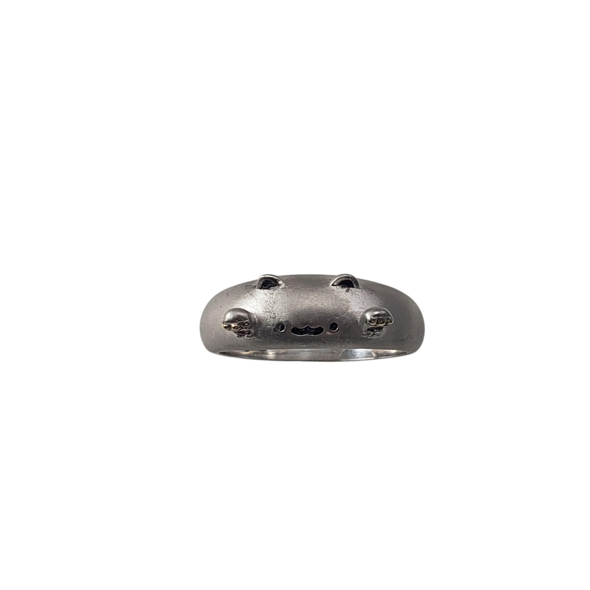18 Karat White Gold Bongo Cat Ring Size 7.5-7.75

This playful ring features an adorable cat face inspired by the Bongo Cat meme, where a cartoon cat plays bongos with its paws. Two little ears are on either side of the band and two paws stick out