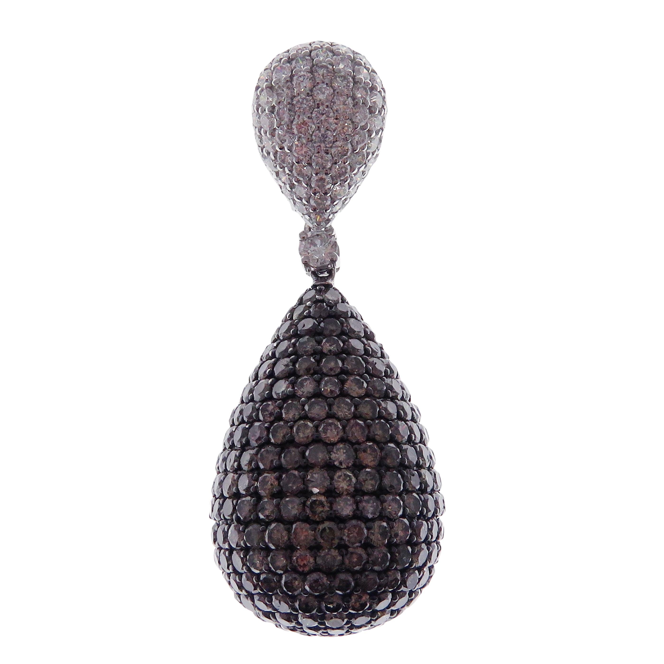 These pear drop pave earrings are crafted in 18-karat white gold, weighing approximately 20.50 carats of brown/champagne diamond with 874 round diamonds. French clip backing. 

Beautiful 0.15 pt white diamond accent on each earring and