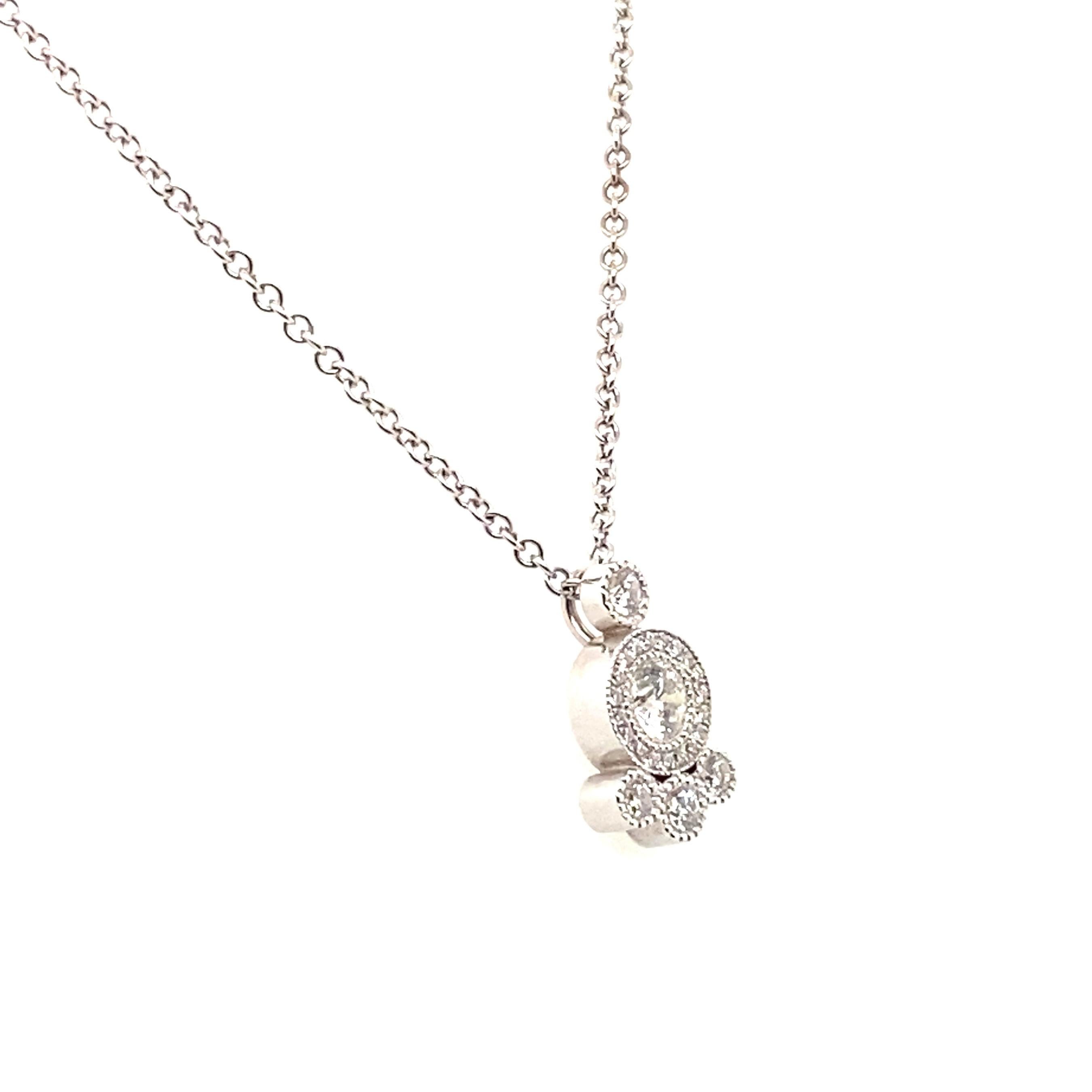 18 Karat white gold hand made diamond pendant featuring:
.25 Carat Forevermark diamond - responsible sourced with beautiful light return. 
The diamonds are framed in round halos  -- 23 round brilliant diamonds  .23 Carat Total Weight  G-H/VS 

.25