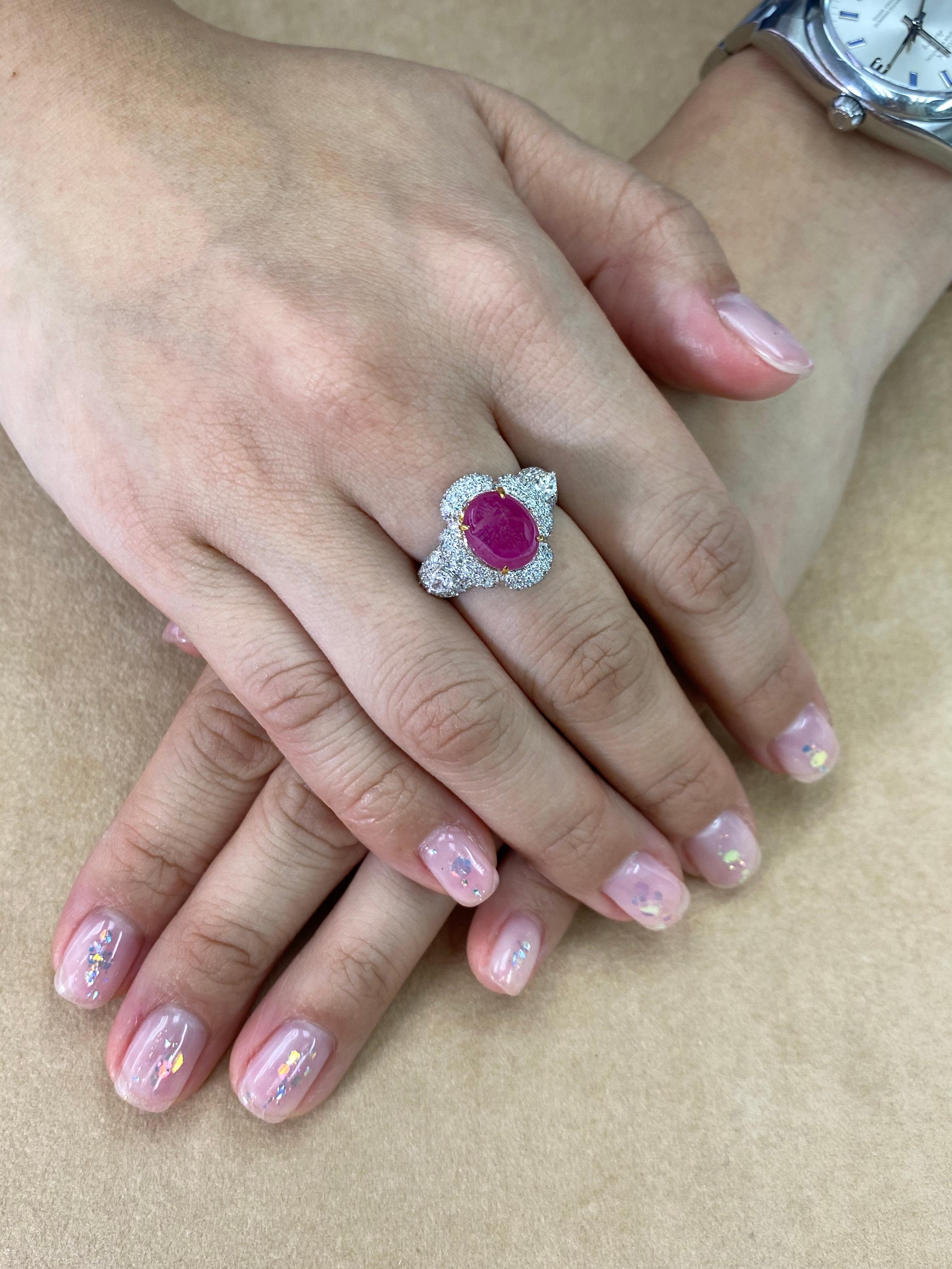 This is a nice piece! Here is a nice larger size pink Ruby and diamond ring. The ring is set in 18k white gold and white diamonds. The center Burma pink ruby cabochon is 3.78cts. There are 2 pear shaped diamonds totaling 0.34cts one on each side of