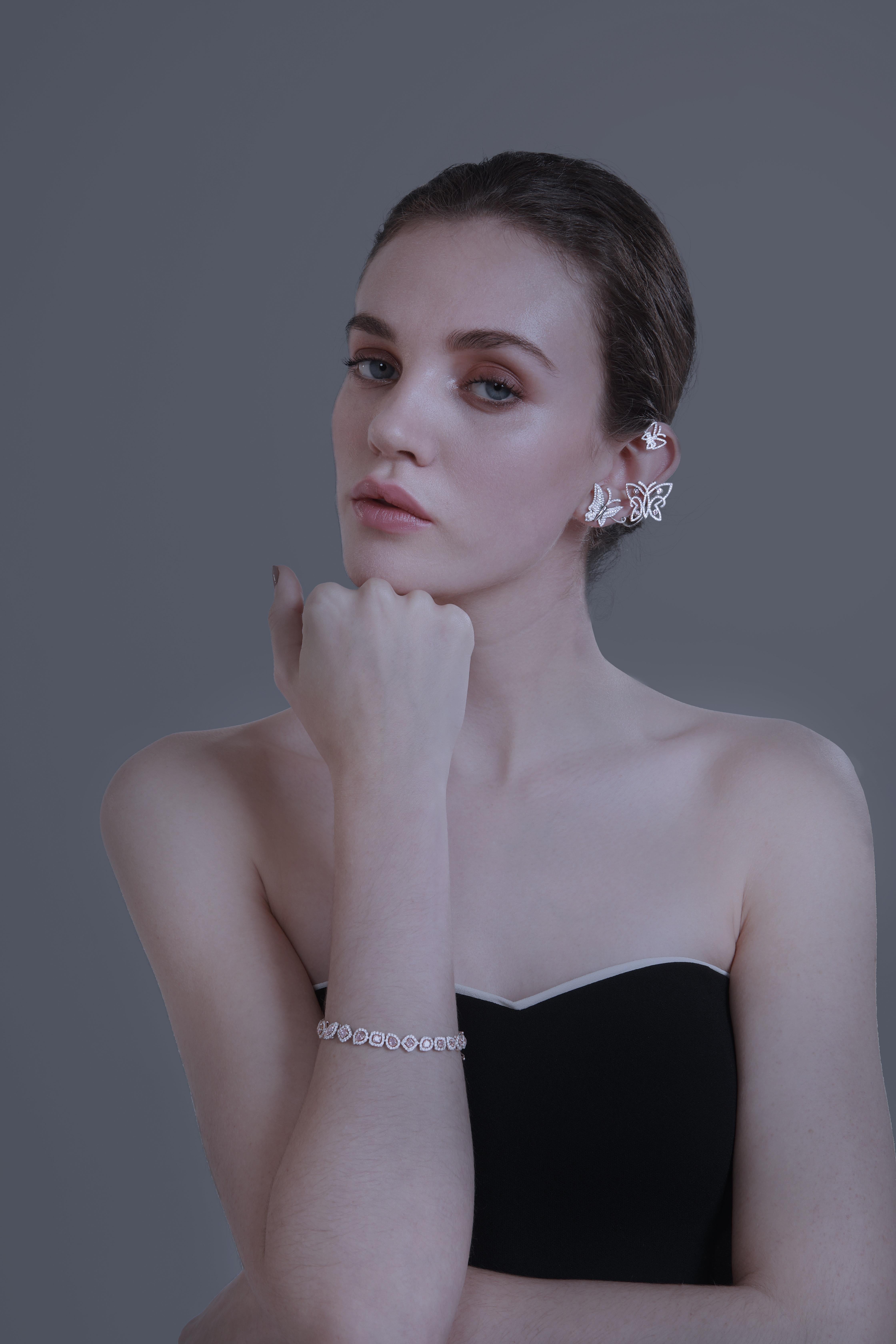 18k White Gold Ear Cuff.

4 Natural Fancy Purplish Pink Round Brilliant Diamonds, Carat Weight: 0.20ct
Over 290 White Diamonds, Carat Weight: 1.73ct

This piece really evokes the delicate and gentle nature of butterflies. It is made to look like