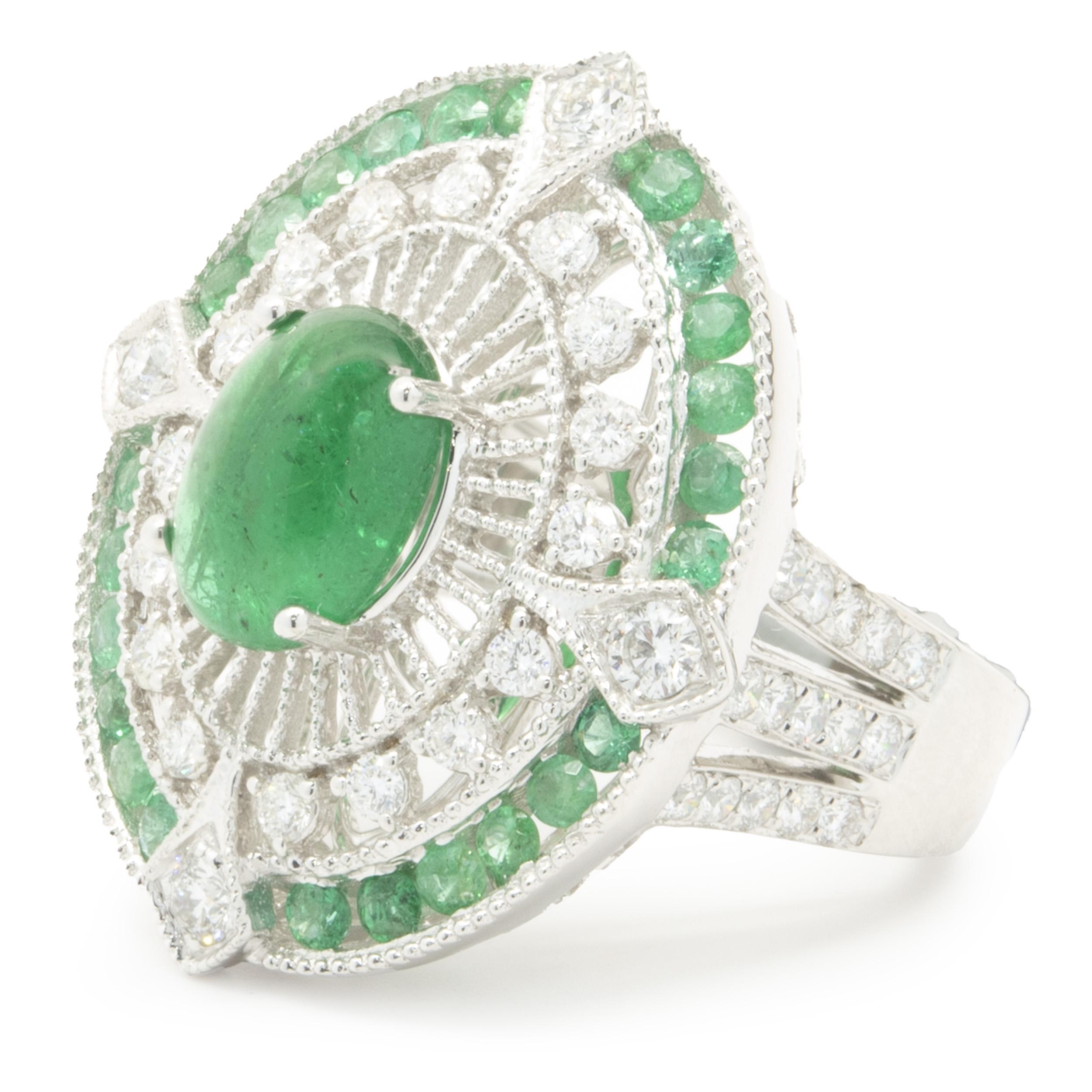 Designer: custom
Material: 18K white gold
Emerald: 1 cabochon cut = 3.00ct
Emerald: 24 round cut = 3.70cttw
Diamond: 50 round brilliant cut = 1.34cttw
Color: G
Clarity: VS2
Ring Size: 6.5 (complimentary sizing available)
Weight: 14.15 grams