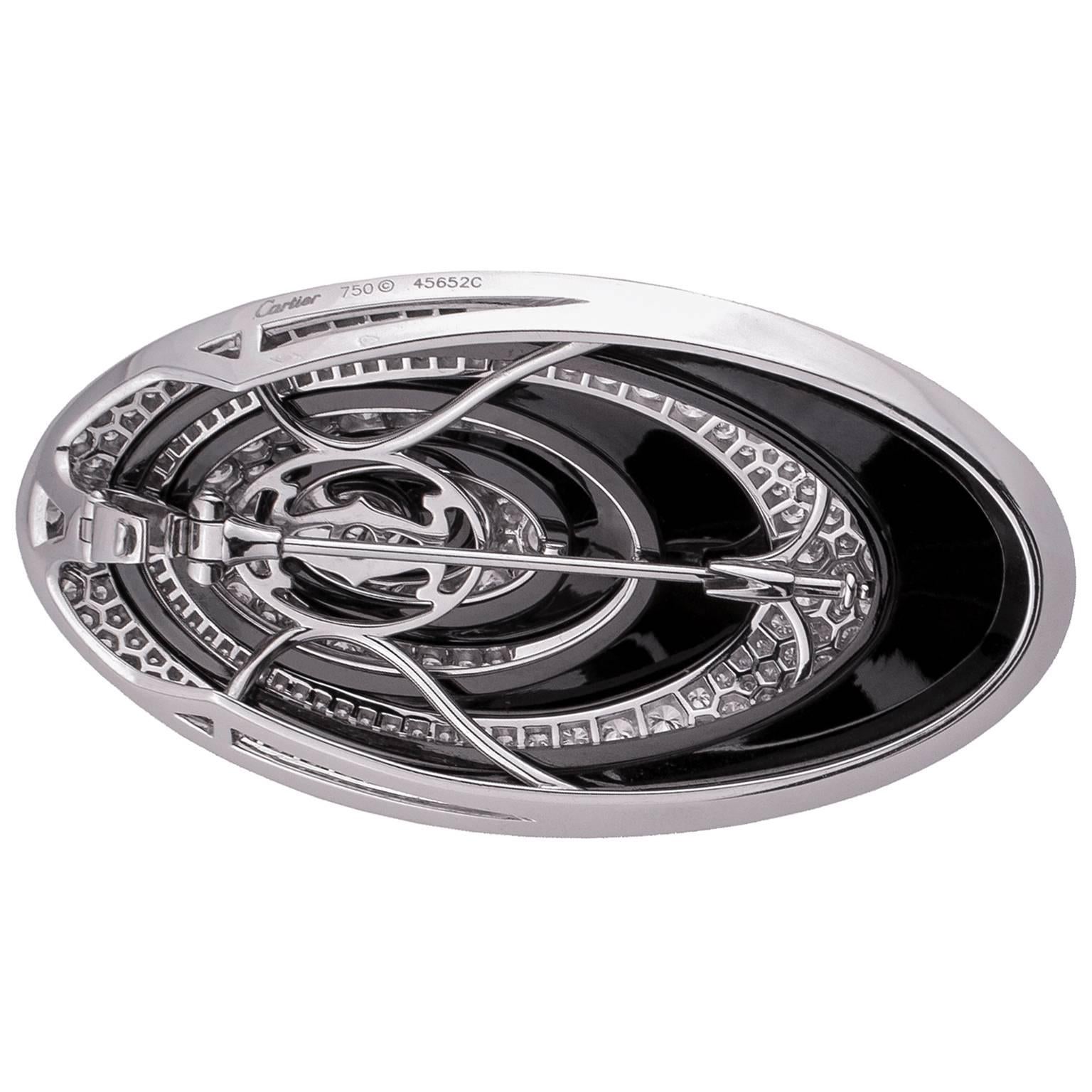 Stunning Cartier pendant in white gold shaped as alternating ellipses of onyx and pave of round brilliant cut diamonds, this piece can also be used as an attractive brooch. Set with a total of 269 round brilliant diamonds in pave setting, totalling