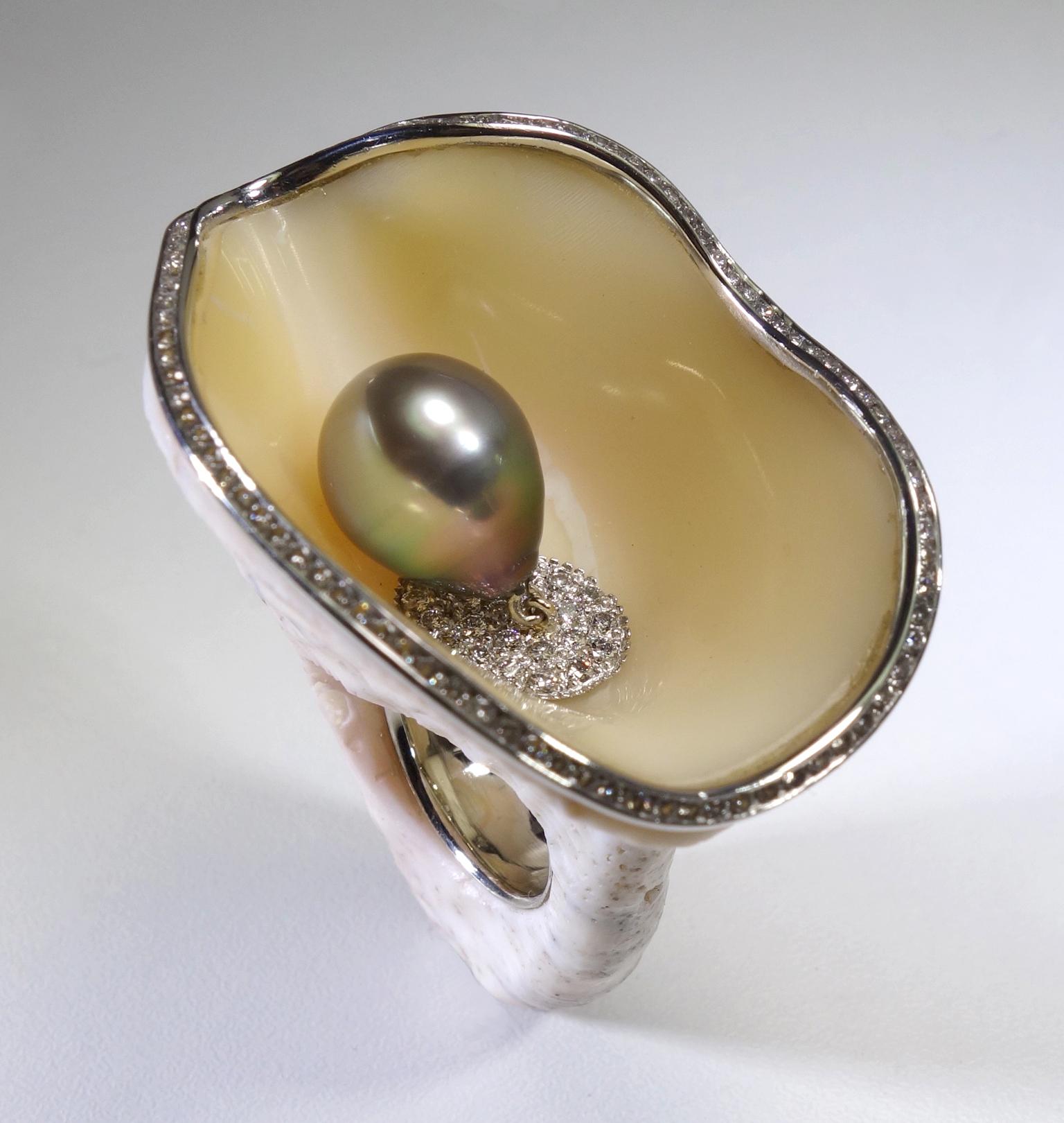 Objets d'Art wearable sculpture on your hand, an organically unique carved abalone shell ring featuring a tear drop shape in peacock color. Tahitian Pearl dangling from 18 Karat White Gold pave' diamond based in a total carat weight of 1.34 and